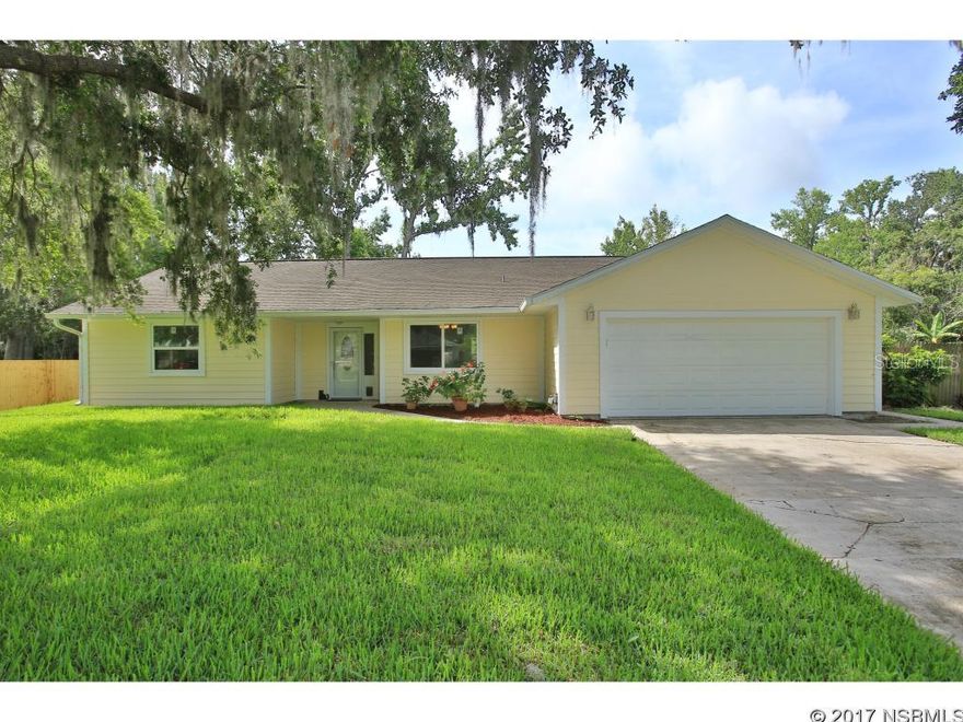 Immaculate, Charming Home on Large Lot in Desirable Corbin Park Neighborhood of NSB.  Surrounded by Beautiful Oaks on a Quiet Street, this 3-bdrm, 2-bath Home has Vaulted Ceilings, & Tile throughout Living Area. Living Room has Wood-Burning Fireplace & French Doors which open to Spacious  Screened Lanai overlooking Beautiful Fenced Back Yard.   Eat-in Kitchen with lots of Cabinets & Counter space with pass through opening  to Living Room.  Formal Dining Room has view of Front Yard.  Master Suite has walk-in Closet & French Doors to Patio.  New upgrades in 2016 include:  Royal Celect Composite Siding, New Impact Windows, New Sod, & New Septic system. New Water Heater in 2014, Irrigation Sys. in 2013, Roof & Ac replaced in 2006. Great ''like new'' home near Shopping, Restaurants & The Beach! ;Water: City