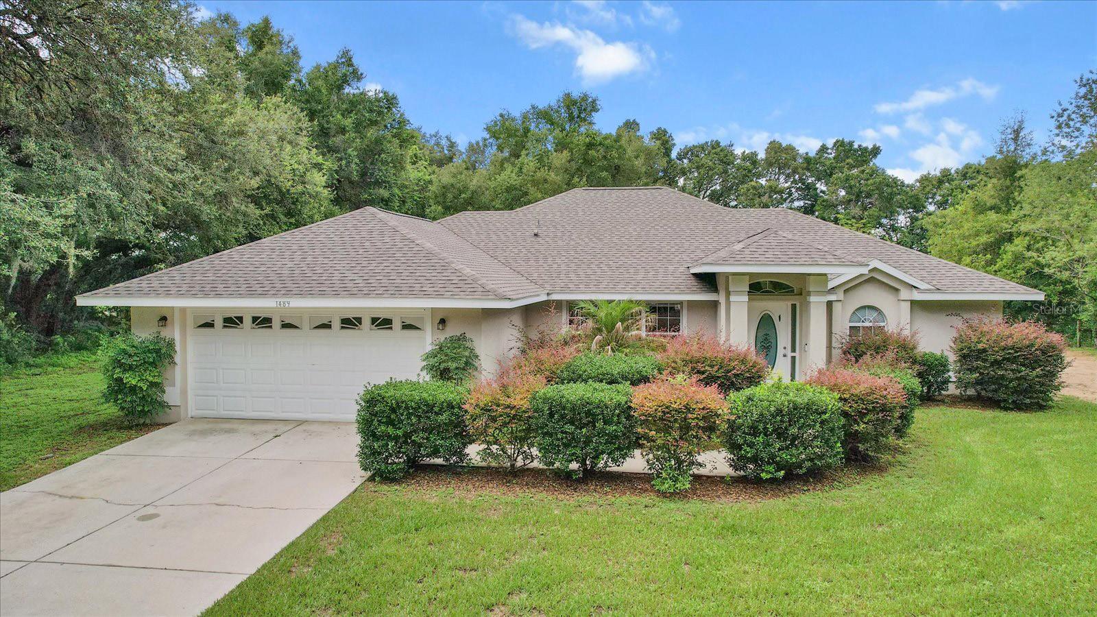 Set on a full acre of serene land, this recently updated 3-bedroom, 2-bath home delivers both comfort and style with over 2,000 square feet of living space. The split-bedroom floor plan offers privacy and functionality, complemented by fresh interior and exterior paint, a brand-new roof, a new septic system, and a newly installed HVAC system for year-round efficiency and peace of mind. The spacious living area features vaulted ceilings and durable luxury vinyl plank flooring throughout, flowing effortlessly into a well-appointed kitchen with stainless steel appliances and rich wood cabinetry. Enjoy the convenience of an inside laundry room and the added storage of a 2-car garage. A large screened lanai extends your living space outdoors—perfect for relaxing in the quiet, natural surroundings. With easy access to major roadways, you’re never far from shopping, dining, and Central Florida’s key destinations. This move-in ready home offers the ideal blend of rural tranquility and everyday convenience.Call for your showing today!