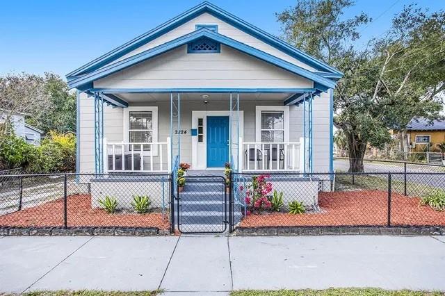 Historic 4 bedroom, 2 bath home on a fenced corner lot with covered front and rear porches. Recent updates include *BRAND NEW ROOF*, freshened interior paint, new duct work, updated electrical panel, new landscaping, high-voltage disconnect panel, leaf guard protector on condenser, and a whole-home air purification system with transferable warranty. Kitchen features stylish cabinetry, stainless steel appliances, breakfast bar, and ample storage. High ceilings, bright walls, and neutral flooring throughout. A/C 2021, water heater 2017. Just minutes from Historic Ybor City, Columbia Restaurant, Armature Works, and Downtown Tampa!