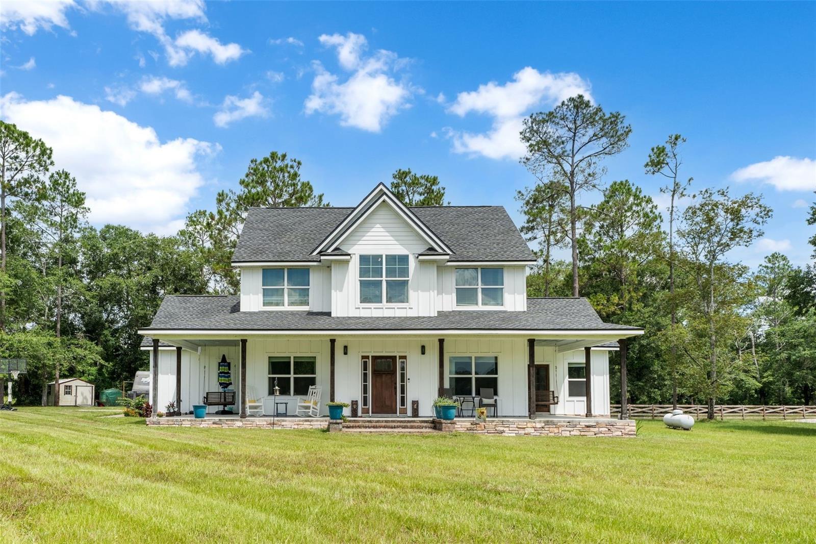 Tucked away on a beautiful 1-acre lot, this thoughtfully designed custom home offers space, comfort, and timeless style. Boasting 4 bedrooms, 2.5 bathrooms and a versatile office, this home was built with functionality and luxury in mind. The chef’s kitchen is a showstopper with rich wood shaker cabinetry, sleek quartz countertops, stainless steel appliances including a gas stove, and a spacious walk-in pantry. Enjoy the warmth of the gas fireplace in the inviting living room, or entertain in the formal dining space. The main level also features luxury vinyl plank flooring, a mudroom, laundry room, half bath, primary suite and a convenient storage closet under the stairs. Upstairs, you'll find three additional bedrooms, full bath with dual vanities, and a bonus living area perfect for relaxing or play.
The expansive primary suite offers a peaceful retreat with a spa-like bathroom featuring a free-standing soaking tub, walk-in shower with double shower heads, double vanities, and a generous walk-in closet. Modern touches like Ecobee smart thermostats on both levels and a gas tankless water heater add comfort and efficiency.
Step outside to enjoy the tiled back porch, fully sodded and professionally landscaped, fully fenced yard, perfect for pets or play. Additional upgrades include durable Hardie board siding with cedar beam accents, a charming front porch, side porches with a swing, a 2-car garage, and a whole-home water softener system. This home is move-in ready and built to impress!