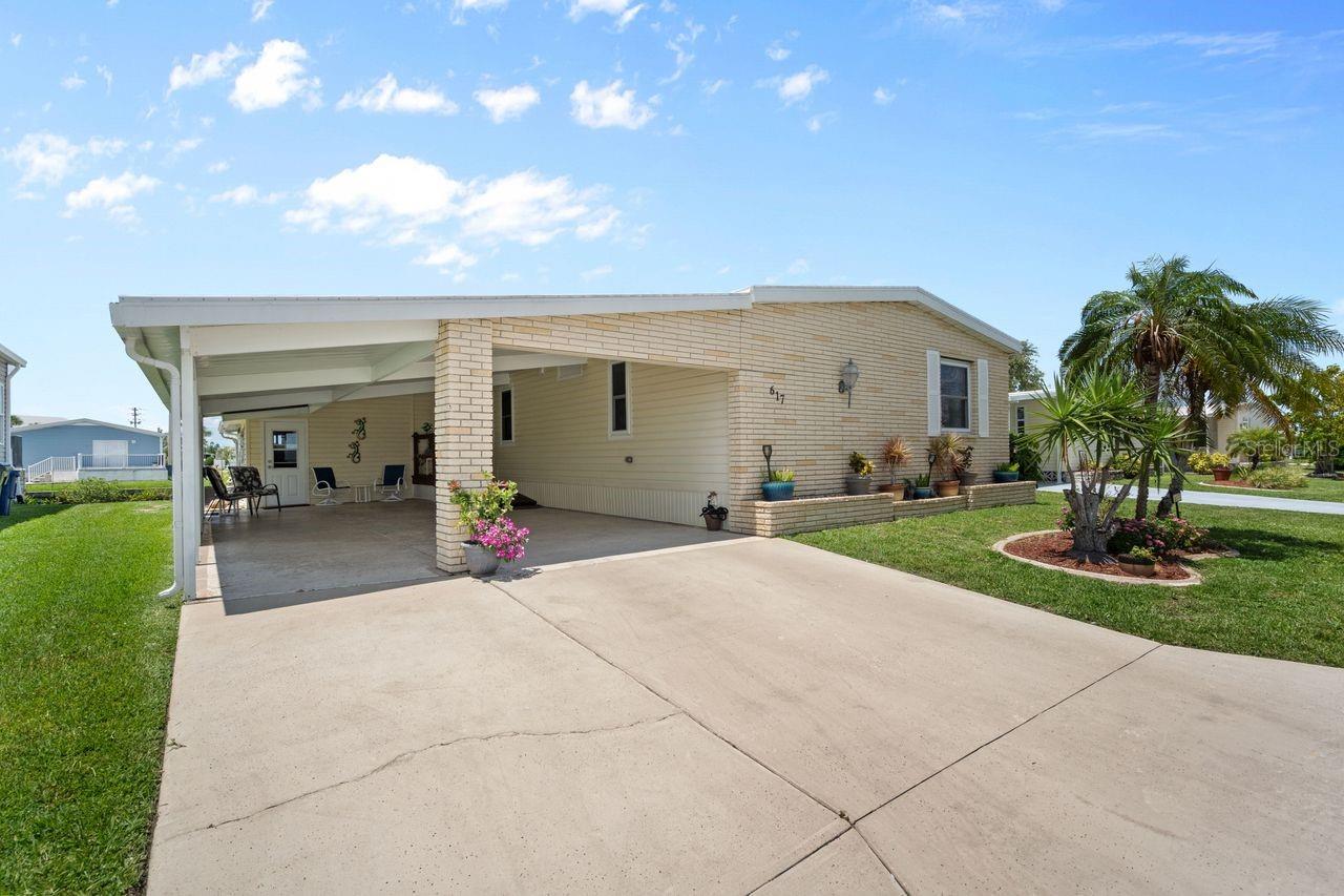 A very unique find within the 55+ GULF ACCESS community of Harbor Cove! This FURNISHED 2 bedroom, 2 bathroom, CANAL FRONT home with DOCK has approx. 1420 sq. ft., including an enclosed 220 sq. ft. Florida room with beautiful water views! Outside the brick front, extra large carport, plus attractive landscaping set the stage for what’s to follow. This well maintained residence in the PET SECTION is nicely updated and has a welcoming coastal vibe and décor. The kitchen has plenty of cabinetry and counter space, a breakfast bar, closet pantry, stainless steel appliances, an opening to the living room and a dining room with built in hutch nearby. Decide between dining and entertaining friends with stunning sunset views from the Florida room, the covered and screened lanai, or the waterfront patio. The large living room is nice and bright with plenty of windows and sliding doors direct to the Florida room. The impressive and spacious primary suite has a large walk-in closet and a remodeled ensuite bathroom with attractive cabinetry and tiled shower. The updated hall bathroom is handy for visitors staying in the well-appointed guest room with dual closets. You'll find lots of storage space in the attached shed with laundry area. Many recent UPDATES including new roof, vapor barrier, luxury vinyl flooring, and re-plumb (2025), hot water heater and washer and dryer (2024), A/C system and appliances (2022), plus impact windows and more. HOA fees of only $150 per month cover seawall maintenance, mowing and access to two swimming pools, hot tub, fitness center, sports courts and a 17,000 sq. ft. clubhouse overlooking the picturesque marina. Join the boat club and make friends at dances, holiday events, trivia, card games, golf cart parades and other organized events. Boating and fishing fans can just jump in their boat in the backyard and go explore the majestic Myakka River all the way to the Gulf. Nearby are restaurants, golf courses, spring training baseball stadiums, farmers markets, quality healthcare and several area beaches. Schedule a showing today to view this lovely property!
