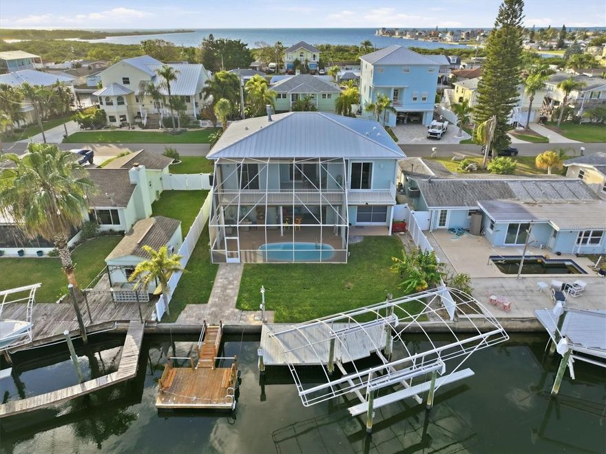 Boaters’ Paradise with Direct Gulf Access & Stunning Water Views

Live the ultimate Gulf Coast boating lifestyle in this exceptional 3-bedroom, 2-bath stilt home with a screen-enclosed pool, Gulf views, and direct Gulf access. Perfectly positioned on 59 feet of saltwater canal frontage, this waterfront retreat offers no fixed bridges to the open Gulf—just idle out and you’re on your way. A 10,000-lb covered boat lift, fixed dock, and floating dock make this home ideal for serious anglers and recreational boaters alike. Watch dolphins and manatees glide past your backyard while you fish for redfish, snook, and snapper right from your dock.

Designed for relaxed coastal living, the home features screened second-story porches front and rear, capturing cooling breezes, canal views, and partial Gulf views—perfect for sunrise coffee or sunset cocktails. The screened pool area creates a private oasis for entertaining or unwinding after a day on the water. A convenient garage bathroom adds functionality for pool and boating days.

Recent upgrades and highlights include:
2025 hidden fastener metal roof
2024 new Florida glass poolside enclosure
2024 new pool pump
2024 waterproof, rot-proof full-width rear porch decking
2022 all-new double-pane windows (9 total), including garage
2022 stainless-steel refrigerator
2024 new water softener
Stainless-steel appliances
Fully Fenced Yard 

Located in Hudson Beach, a true boating and fishing community just north of Tampa, this area is known for its laid-back, old-Florida coastal charm—often compared to Key West in the 1970s. With easy Gulf access, waterfront tiki bars, marinas, fresh local seafood, and unforgettable sunsets, boating isn’t just a hobby here, it’s a way of life. Enjoy quick access to US 19 for shopping, dining, medical facilities, and everyday conveniences, with Tampa International Airport about an hour away.

If you’re searching for direct Gulf access, protected dockage, and an authentic Gulf Coast boating lifestyle, this Hudson Beach waterfront home delivers it all.
