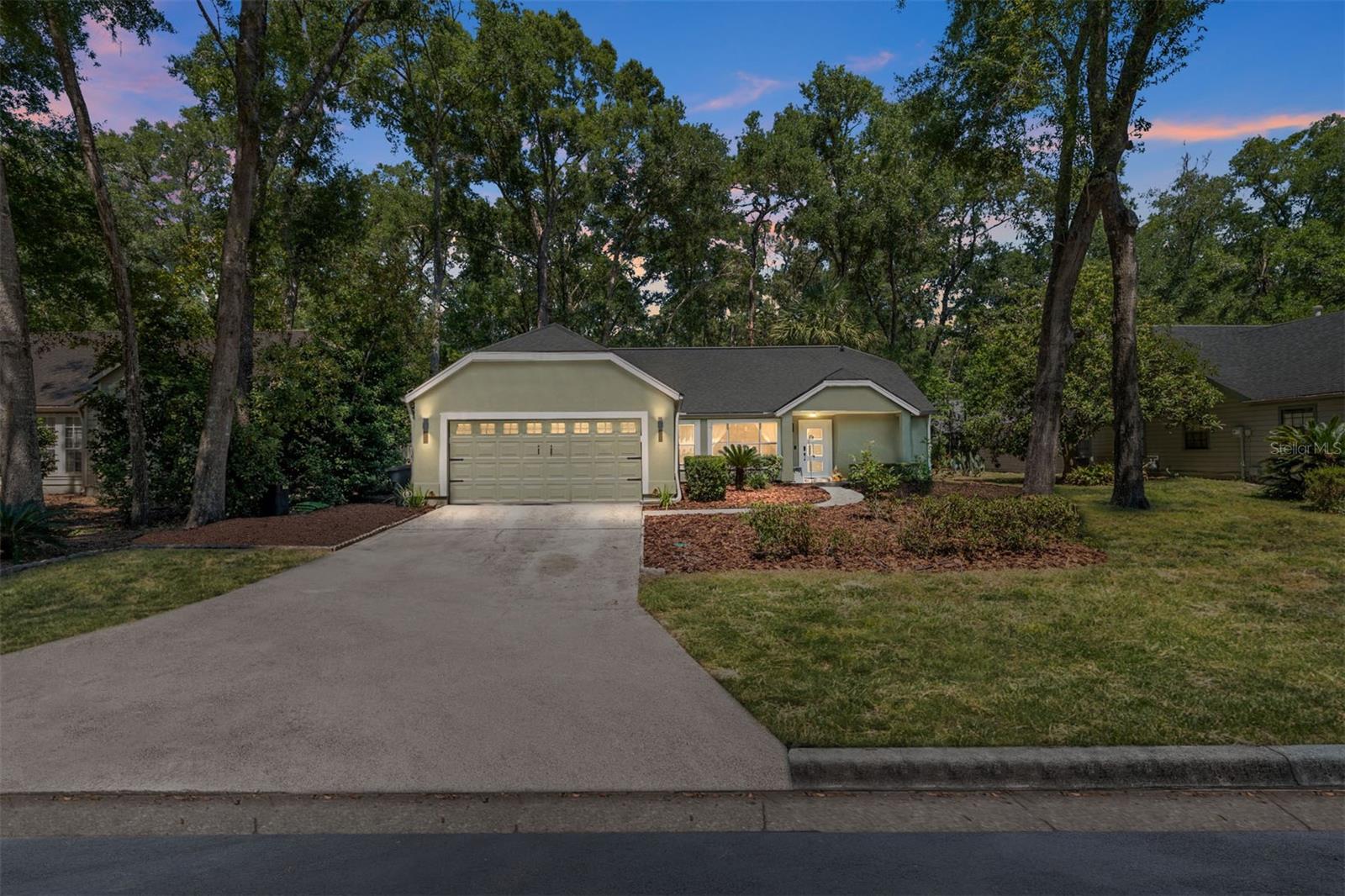 Rarely Available in Southerland Crossings – Designer 4BR/2BA in Haile Plantation
Welcome to this beautifully renovated 4-bedroom, 2-bath home tucked into a quiet cul-de-sac in the rarely available Southerland Crossings neighborhood of Haile Plantation. With 1,756 sq ft under air, a split-bedroom floor plan, and a 2-car garage, this home offers both functionality and luxury with extensive upgrades from 2019 to 2025.
Step inside and be wowed by the ledger stone wood-burning fireplace, wood laminate floors throughout, and smart home integration featuring a Nest thermostat and Philips Hue smart lighting inside and out. The screened-in patio with PVC deck tiles opens to a fully fenced backyard with lush landscaping — perfect for relaxing or entertaining.
The primary suite is a true showstopper. The master bathroom was extensively remodeled in 2024 and features:
• Calacatta marble tile flooring
• Floor-to-ceiling Calacatta marble accent walls
• Floor-to-ceiling wood-grain tile shower walls
• Wall-hung solid birch wood vanity with soft-close drawers and hinges
• Miami White quartz square-cut countertops
• Trough sink with dual Delta Champagne Bronze faucets
• Toto wall-hung tankless toilet
• Walk-in curb less shower with 72” linear tile drain
• Delta Champagne Bronze rain head, dual-head shower column (3 heads total)
• Matching Champagne Bronze cabinet hardware and robe hooks
Additional upgrades throughout the home include:
• New Trane HVAC (2024) with HEPA air filtration and Halo Reme UV air purification
• Navien 180-A tankless gas water heater
• New insulation (2024) throughout and A/C’d, insulated garage
• Kitchen remodel (2019) with Kenmore Elite stainless appliances and granite countertops
• GE all-in-one ventless washer/dryer combo
• Interior & exterior paint (2024) including fence and doors
• All-wood wainscoting, 8” baseboards, upgraded trim, and Venetian plaster finishes
Located in the heart of Haile Plantation near walking trails, parks, dining, and top-rated schools, this home blends timeless elegance with modern convenience. Homes in Southerland Crossings rarely come available—don’t miss your chance to own this thoughtfully renovated gem.
