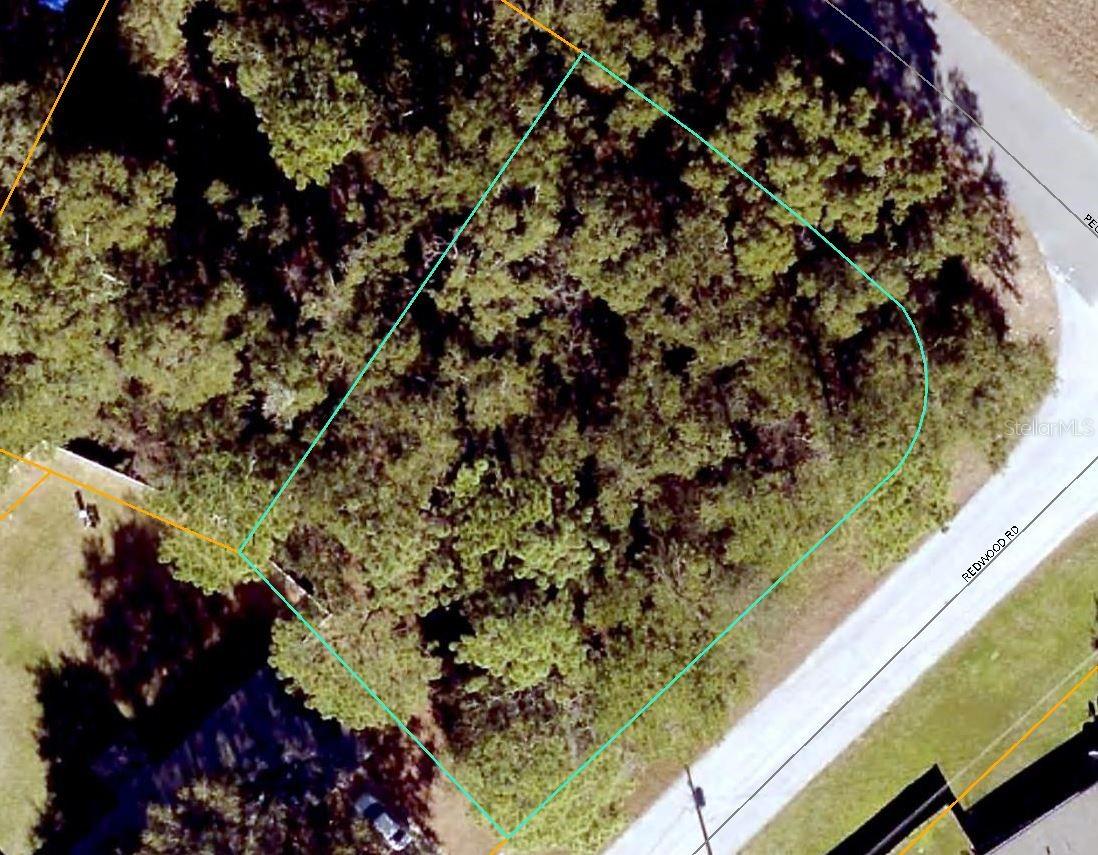 NO HOA!! Nicely wooded corner lot in Silver Springs Shores. 105 ft of paved road frontage. Located in area of nice residential homes. You choose the builder and when you want to build.