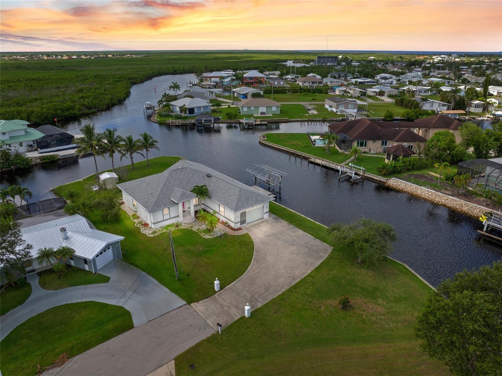 WATERFRONT LIVING WITH SAILBOAT ACCESS — This Punta Gorda home offers the ultimate boater’s lifestyle on a wide saltwater canal with no bridges, just minutes to open water and Charlotte Harbor. ALL FURNISHINGS ETC that are in the home are included with the sale!!
The composite dock, equipped with electric service, a lift, and a concrete seawall, makes it easy to keep your boat ready for your next fishing or cruising adventure. With over 350 feet of waterfront, you’ll enjoy panoramic canal views from the spacious screened lanai and covered porch.
Inside, the thoughtfully designed layout features vaulted ceilings, split bedrooms, a large living room, formal dining space, and an open kitchen with solid surface counters and pantry. The oversized primary suite includes a walk-in closet and en-suite bath, while two additional bedrooms provide comfort for family and guests.
Spend your days fishing for snook, redfish, and tarpon right from your dock or head out to Charlotte Harbor and the Gulf. By boat, you can reach a variety of waterfront restaurants and tiki bars, Punta Gorda’s historic downtown, Fishermen’s Village marina & shops, or simply anchor up to watch the sunset. On land, enjoy nearby golfing, marinas, farmers markets, live entertainment venues, parks, and walking paths. This location offers a rare combination of quiet, dead-end street privacy and convenient access to Punta Gorda’s vibrant waterfront lifestyle.
Whether you’re seeking a full-time residence or a seasonal retreat, this sailboat-water home is an incredible opportunity to live where others vacation. This is a custom built one owner home!