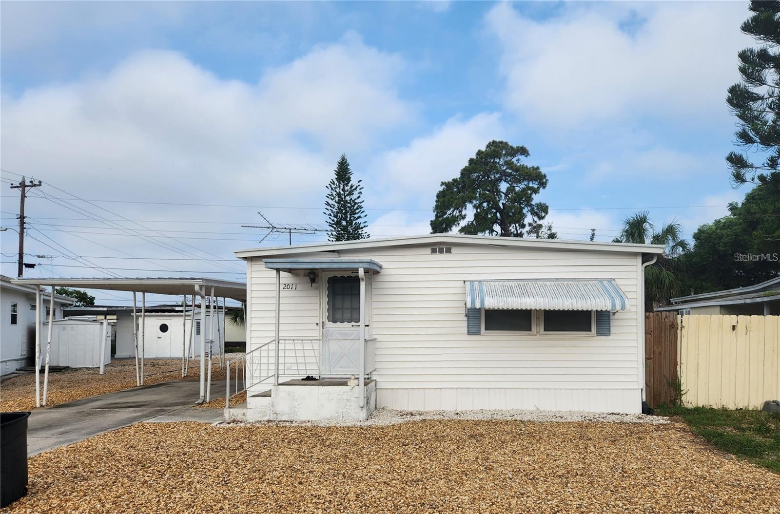 2 bedroom 1 bath 1970 Double-wide Manufactured home in the popular Buena Vista Community. Perfect starter home, investment property or vacation home. Tenant occupied. Tenant is paying $1195 a month in rent, giving a great 14-15% return to an investor. This AS-IS property features new carpet throught. Not in a flood zone. Low HOA fees include Clubhouse access, trash and street lights. Property has a large carport and additional storage shed in back. Enter into the spacious living room/ding room area and continue on to the kitchen and split bedroom setup. There is also a large Florida room located in the back of the home. Centrally located just west of US Hwy 19 with easy access to all Pinellas County beaches! Don't miss out!