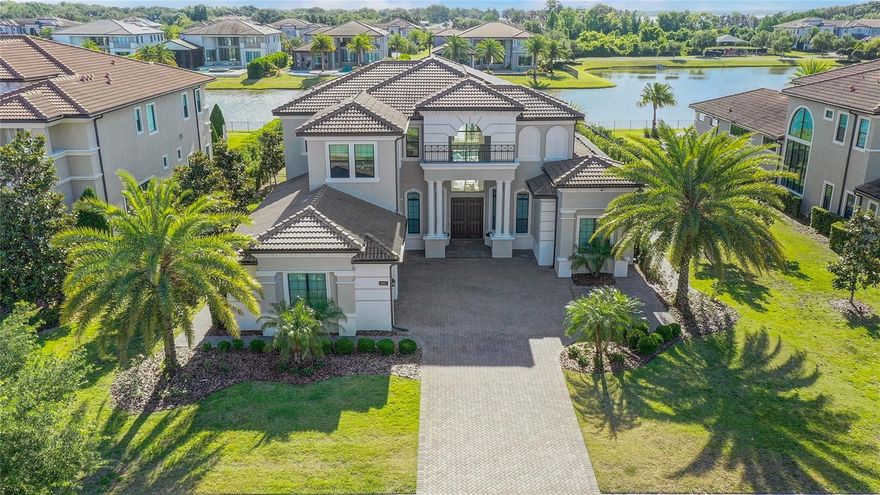 IMMEDIATELY AVAILABLE, Buyer Unable to move forward due to personal reasons with this purchase... Here is your opportunity.      Located in the esteemed gated community of Casabella, Windermere. The home is situated next to the beautiful community man-made landscaped lake. So always enjoy the peaceful water views from the house, pool, spa or on the rear deck. This stunning Toll Brothers built property offers a grand, light-filled first floor, featuring an expansive open living space, a luxurious primary bedroom suite, guest bedroom, and an office study. Notice the impressive full height feature window wall, high ceilings with impeccable finishes, every aspect exudes opulence. Chef's kitchen with sleek cabinetry, an island and breakfast nook that all exude sophistication, a feature transparent backsplash, complemented by luxurious countertops that elevate the aesthetic. Equip it with top-of-the-line appliances, such as the prestigious Wolf range gas top and oven, renowned for precision cooking, and a Sub-Zero refrigerator and freezer, ensuring optimal food preservation and freshness. Two dishwashers, wine cooler and custom wood cabinetry add a touch of elegance to the home. Enjoy several first floor living spaces that include a fireplace and numerous built in feature display shelves. Upstairs, there is a loft space and three more good sized bedrooms including one with a nightly view of the Disney fireworks show.  Outside, the lavish pool and heated spa awaits with its modern design and serene water views. There is a designer outdoor kitchen with electric screens. This  home is a haven of modern convenience and sustainability. With a water filtration system ensuring clean, refreshing water at every turn, and a robust 16 kW solar panel system paired with 5 Powerwalls, an on demand gas water heater, minimizing the environmental footprint while enjoying reliable energy independence. The outdoor oasis has illuminated landscaping and can be seamlessly managed with a Wi-Fi enabled pool system, keeping water pristine and pool functions at our fingertips. Safety is paramount, with a Simplisafe alarm system safeguarding this home. Surveillance is comprehensive yet discreet, courtesy of a 16-camera system, and the landscape comes to life after dark with a tasteful illumination setup. Indoors, convenience reigns with remote-controlled blinds and custom closets maximizing space. The oversized garage provides space for up to three cars and includes an electric charging station. The expansive paver driveway enhances both aesthetics and functionality.  Conveniently located for highly rated schools, local amenities including restaurants, shopping centers, parks, and golf courses, this community epitomizes upscale living.