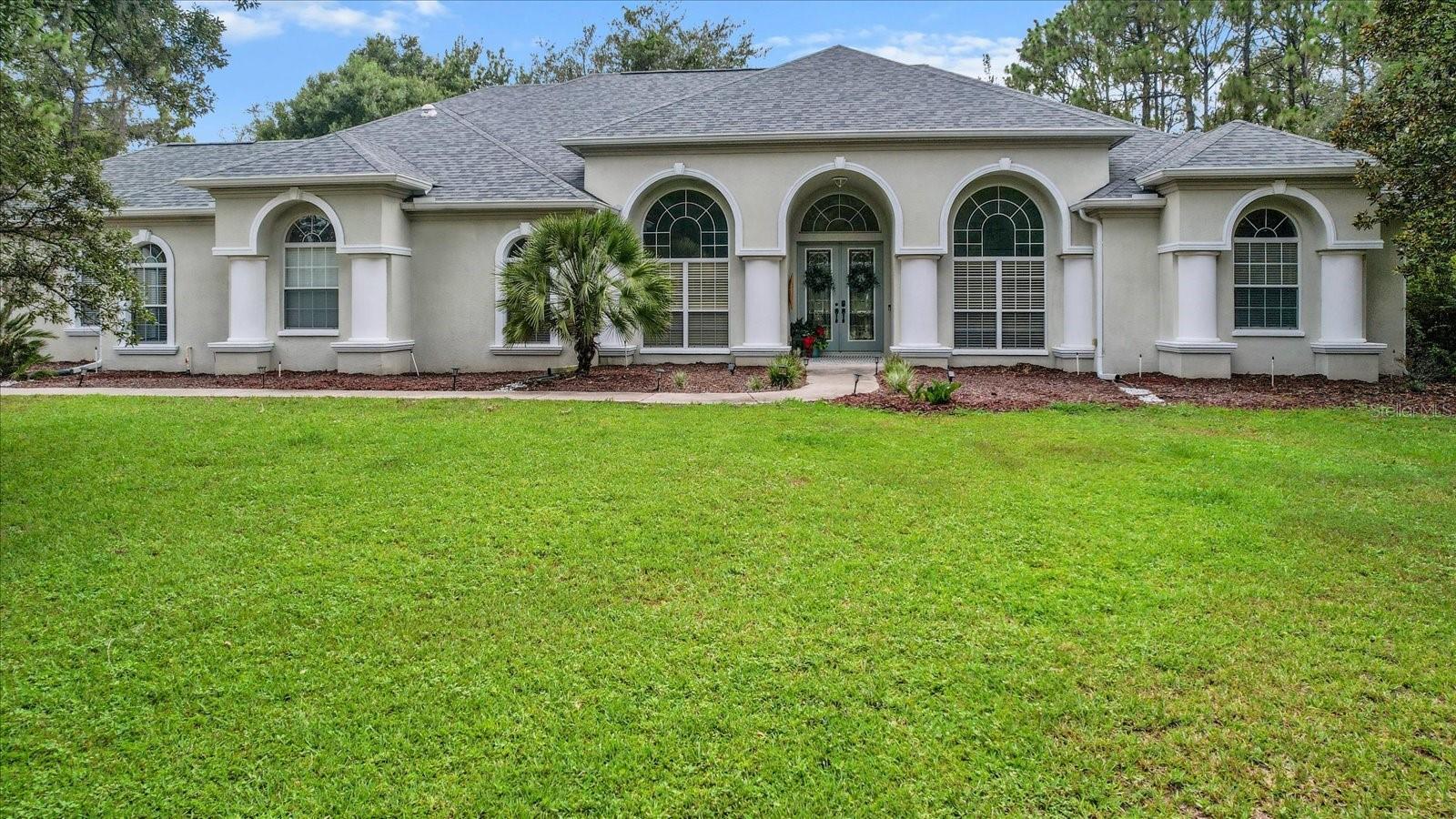 Welcome to your private Florida retreat! This beautiful golf course home located in Pine Ridge Estates is perfectly designed for entertaining and relaxing. The gorgeous well-appointed gourmet kitchen includes stone countertops, center island, walk-in pantry, built-in microwave, double ovens & duel-energy gas range. The expansive owners suite offers oversized closets, resort bathroom with jetted tub, walk through shower with dual rain shower heads, seating and separate vanities. The deep driveway wraps around to the oversized 4 Car garage. The1.06 acre property with fenced yard offers privacy while still in neighborhood setting. This home features a NEWER ROOF (NOV 2022), hot water heater (2022), deep well for irrigation (2022), RECENTLY SERVICED full house Generac, 2 AC Units (2025 & refurbished 2024). The 3 panel glass pocket doors open to the expansive Lanai with sparkling heated pool & spa. Pool pump (2022) Gas heater (2024)Pool Sweep (2024). Schedule your showing today!