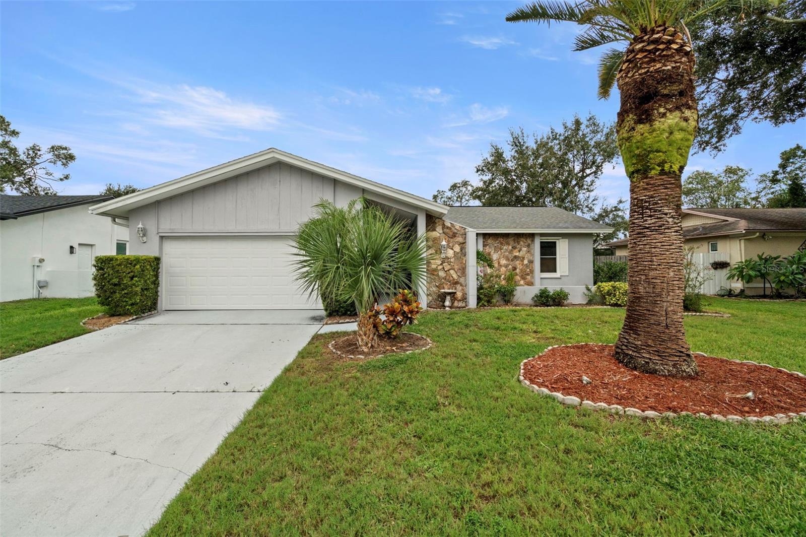 From the moment you walk through the front door, your view of the pool is so inviting you want to dive right in! Welcome to this charming three-bedroom, two-bath single-family home nestled in the desirable community of Safety Harbor, Florida. This inviting residence boasts a newer roof (2020), ensuring durability and peace of mind for years to come. As you enter, you'll appreciate the spacious layout that seamlessly connects the living areas, perfect for both relaxation and entertaining. Huge wood burning fireplace and vaulted ceilings make for great evenings with friends. The home features efficient air conditioning (2016), keeping you comfortable during the warm Florida months, along with a newly installed (2024) water heater for your convenience. The remodeled kitchen features beautiful cabinets, granite and stainless steel appliances. New garage door and opener add to your safety and security along with storm shutters and newer windows.
Step outside to discover your very own private oasis, highlighted by a sparkling pool that invites you to unwind and enjoy the sunshine. The surrounding space is ideal for hosting summer barbecues or simply lounging with family and friends. Additionally, the attached garage provides convenient parking and ample storage space, making everyday living a breeze.
Location is key, and this home is perfectly situated just half a mile from the picturesque Philippe Park, offering beautiful walking trails, picnic areas, and stunning waterfront views of Tampa Bay. With its blend of comfort, convenience, and outdoor leisure opportunities, this property is an exceptional find. Don’t miss your chance to experience the best of Safety Harbor living—schedule a showing today and envision your life in this lovely home!