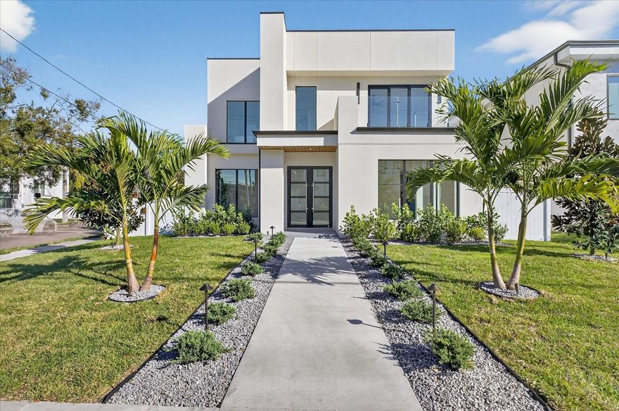 Step into this beautifully designed South Tampa home filled with natural light, modern finishes, and a layout that feels spacious and easy to live in. Oversized impact windows brighten every level, while wood plank flooring runs through the living spaces and bedrooms, giving the home a clean, polished look. Near the entry, a built in wine rack is tucked into a niche behind the front door, adding a subtle design detail that complements the home’s modern aesthetic.

This 3 bedroom, 3 bathroom home also features a dedicated office on the main level, ideal for working from home or creating a quiet flex space. The custom kitchen is the heart of the home, featuring a gas cooktop, Taj Mahal countertops, floor to ceiling cabinetry, designer LED lighting, and a large island ideal for everyday living and entertaining. The open layout connects seamlessly to the main living areas, making the space feel both functional and inviting.

Upstairs, a large loft offers an additional living area perfect for a media room, game room, or lounge and has been enhanced with custom built in cabinetry and a wine refrigerator, along with access to an upstairs balcony. The primary suite features a well appointed bathroom with floor to ceiling tile, oversized tile to minimize grout lines, illuminated mirrors, a freestanding soaking tub, and a frameless glass walk in shower. Secondary bathrooms continue the modern aesthetic with clean finishes and thoughtful details.

Outdoor living is designed for both relaxation and entertaining with a fenced yard, covered patio, and a saltwater pool with sunshelf creating a private backyard setting. Two upstairs balconies and glass railings inside and out enhance the home’s modern design. Additional features include CAT 5 wiring and designer LED lighting throughout.

Conveniently located within walking distance to Bayshore Boulevard and offering easy access to the Crosstown Expressway, Water Street, downtown Tampa, and surrounding dining and entertainment, this home offers a desirable South Tampa lifestyle in a prime location.