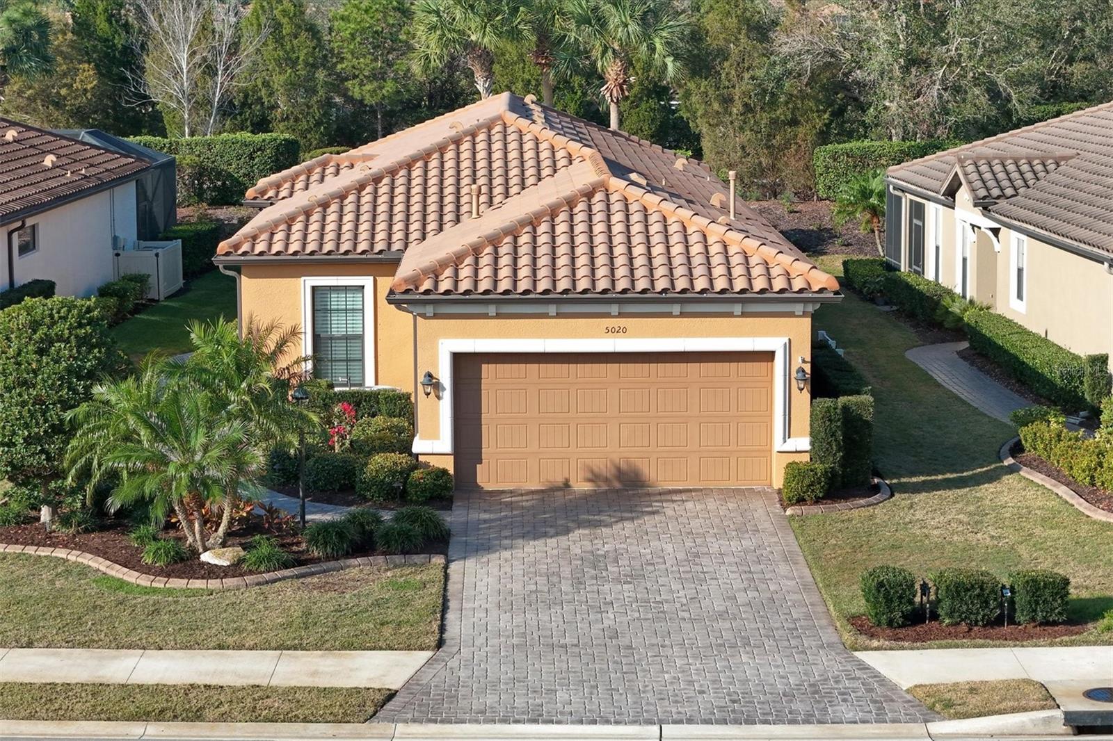 New Price ! Come live the Lakewood Ranch Lifestyle at the Amenity-Rich Esplanade Golf & CC - in the center of all that Lakewood Ranch offers! You're a short walk from both community clubhouses where you will enjoy socializing with your friends and neighbors at the World-Famous Bahama Bar, relish the chance to play Tennis and Pickle ball, spend down time at the spa, catch a workout in the state of the art fitness center, or lounge at one of the 2 resort-style pools! So much to do here - the choice is yours! You can feel comfortable spending the hurricane season in your new home, because it features Lexan See-Thru Hurricane shutters for added protection and to keep things light, and a Whole House Generac Generator to keep your house fully functional during any power outages. The exterior features an extended lanai with an outdoor kitchen, along with a Sun Setter retractable awning, and pull down shades atop a paver deck. Step thru the new artful glass insert front door to the natural light filled unit featuring upgraded kitchen cabinets, stainless steel appliances, tray ceilings, crown molding, a stylish closet system in the main bedroom and a HomeTech warranty protecting the HVAC, Water Heater all appliances and more. Outside, the curb appeal has been enhanced by a Majestic Landscape border and a pressure washing of the exterior walls. Finishing off the home is an epoxy coated garage floor, Safe rack storage racks and a workbench that you will appreciate. Start living the Esplanade lifestyle in Lakewood Ranch today - this home does not include Golf membership so the fees are lower - yet you Can play as a resident should you have guests come to town that do like to tee it up. Come see this house in person and you'll see why you will call Esplanade your new home! Pay and play golf is available for non deeded golf members.