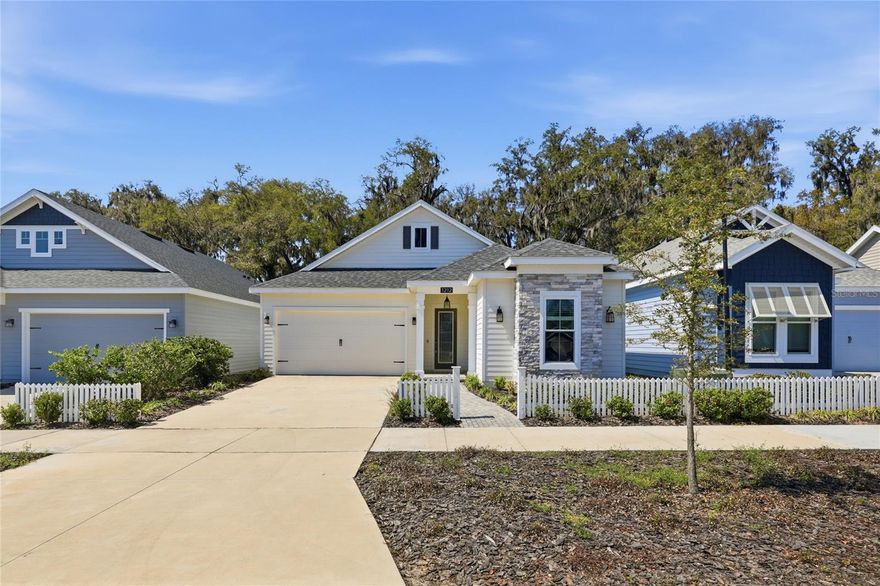 Welcome to Fairway Pointe. Built in 2022 by Kara Bolton, this 3 bedroom, 2 bath home with an office/flex space has a clean, modern feel and a layout that just works.
The kitchen is beautiful—full-height cabinetry in a sharp navy finish, quartz countertops, built-in oven and microwave, gas cooktop, and stainless appliances. It opens right into the main living area, making the space feel open without being too wide or wasted.
The primary suite is well thought out with a connected flow between the bathroom, closet, and laundry—something you don’t always see, but makes everyday life easier.
You’ll notice the wood-look plank flooring through the main areas, higher ceilings, and a lot of natural light coming in off the back of the home.
Out back is where this one separates a bit. The covered porch is set up to actually be used, and the yard backs to a wooded common area with black metal fencing already in place—so you get privacy without losing the open feel.
Hard-board siding with stone accents gives it a nice, clean exterior, and the location is right in the middle of everything—easy access to Jonesville, Newberry, and Gainesville.
It’s a newer home that shows well, lives easy, and sits on one of the better lots in the neighborhood.