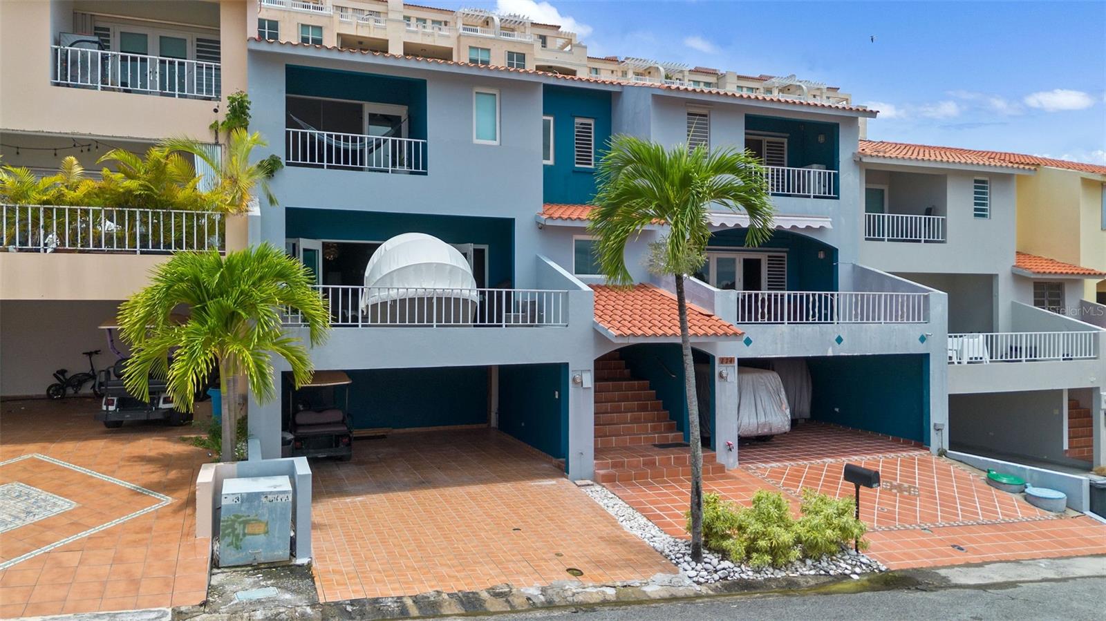 Welcome to your tropical retreat in Palmas del Mar! This two-level townhouse on Montecarlo Street offers the perfect blend of comfort, space, and location. The first floor features an open-concept layout with living and dining areas, a kitchen, laundry space, two bedrooms, and one full bath. The dining room boasts a soaring double-height ceiling, and the expansive front terrace is ideal for relaxing or entertaining. Upstairs, enjoy a private master suite complete with a walk-in closet, an ensuite bathroom, and a tranquil terrace—perfect for catching the ocean breeze. A covered carport adds everyday convenience.
Steps away is the Palmas del Mar Tennis Center, with tennis and pickleball courts, a fitness center, a restaurant, and a pro shop. Just 350 meters away, Palmanova Plaza offers dining, banking, medical services, shops, and more. The beach is only 450 meters from your door, with a children’s park and skate park nearby.
Families will appreciate proximity to The Palmas Academy, a top-rated private Pre-K through 12th grade school offering a bilingual college-preparatory curriculum.
Located within the 2,750-acre gated resort community of Palmas del Mar, residents enjoy access to golf courses, a marina, an equestrian center, and 24/7 security. This property is also approved for short-term rentals, offering great flexibility for investment or personal use.
