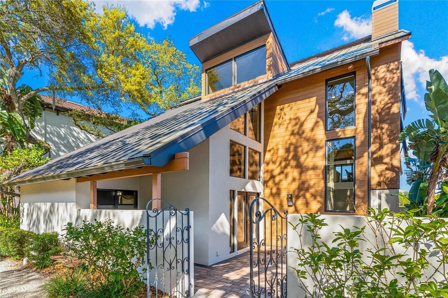 No Hurricane or Flood Damage.  A coastal modern oasis in Siesta Cove, Siesta Key’s premier neighborhood, highlights 80 feet of waterfront with convenient boat access to Gulf and Bay, with newer seawall, boat dockage, and an extraordinary pool that invites you to enjoy Siesta Key’s relaxed lifestyle. Breathtaking Sarasota Bay vistas along the many peaceful panoramic patio terraces provide endless views of nature. On the main floor, a generous kitchen with gas cooktop island opens into the zen fireplace family room and spacious dining room with soaring ceilings and teeming with nature-filled impact windows. Quartz countertops, sleek wood cabinets, and stainless steel appliances for chefs join the jaw-dropping wall of extensive kitchen windows. Additionally, a powder room and spacious guest bedroom complete with en suite bathroom are located on the main level.  Enjoy the top level primary suite, with loft office, secondary laundry room, third large bedroom and en suite bathroom. The lower level features a family room, fourth bedroom, additional laundry room, and a 2 car garage. This modern coastal retreat boasts energy efficient solar panels and is just a short bike ride away from world class Siesta Beach and the Village. Paradise awaits.