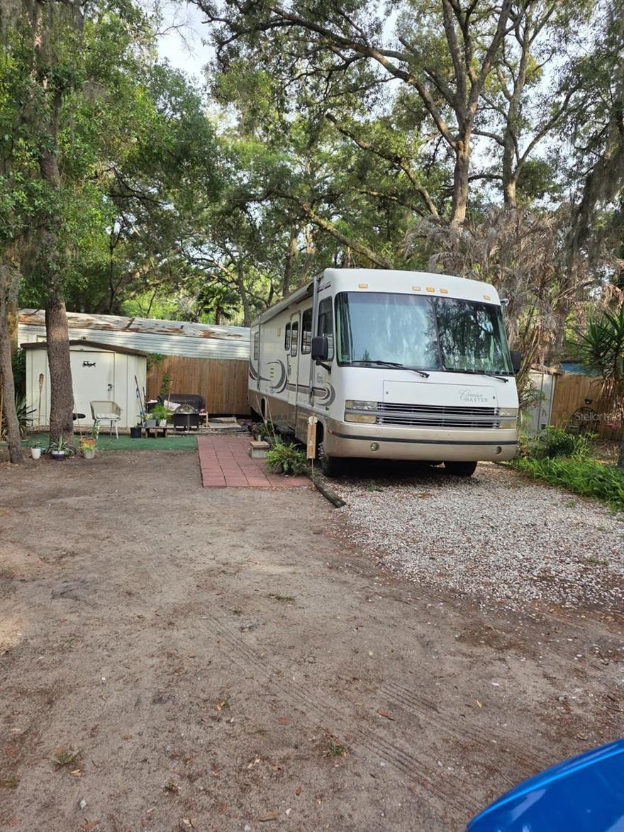 OWN THE LAND! Great opportunity to own in a gated community! This property includes a lot with a remodeled 1-bedroom RV already in place, making it a perfect option for a primary residence, vacation getaway, or investment opportunity. The RV offers a comfortable and updated living space, ready for immediate use. The property also includes a storage shed, providing additional space for tools, equipment, or personal items. HOA dues conveniently cover water, sewer, and trash, helping keep monthly expenses simple and predictable. Enjoy access to community amenities including a large swimming pool, basketball court, mini golf, shuffleboard court, barbecue area and playground, all within a secure, gated setting. Ideally located just minutes from hospitals, shopping, dining, and major roadways for easy commuting. Sold as-is. Don’t miss this unique and affordable opportunity, schedule your showing today!