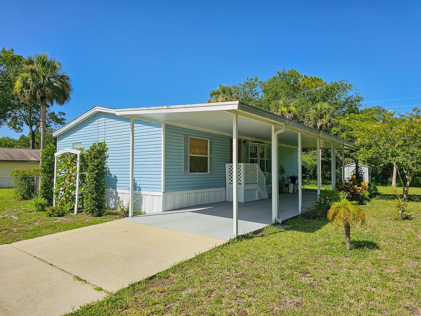 Welcome to this beautifully maintained 2 bedroom, 2 bath manufactured home located on its own lot in the South Waterfront Park subdivision in Edgewater. This home features a functional split floor plan and showcases the pride of ownership throughout. The guest bedroom offers versatile use, featuring custom built-in office cabinetry—perfect for working from home or hosting overnight guests. As you step inside, you'll immediately notice the warmth of the custom wood ceiling beams, a nod to the homeowner's craftsmanship and love for woodworking. Situated just 1.5 miles from scenic River Breeze Park, located on the River and offers access to a public boat launch, playground, and peaceful green space. The park is a favorite for bird watchers and nature lovers, with panoramic views of the river and surrounding wildlife Whether you're seeking a peaceful primary residence or a seasonal retreat, this unique property offers comfort, character, and convenience.