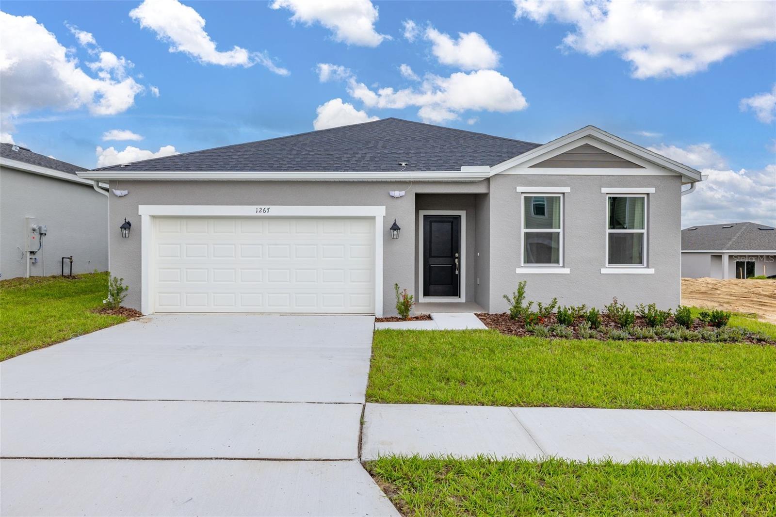 For Rent this beautiful brand new, never lived in Home with 4 bedrooms and 3 full baths. As soon as you walk in, find a long hall with decorative wainscoting wall panels. To the right find a junior master bedroom with a board and batten panel wall, walk in closet and a full bathroom with quartz countertop. Entering the open floor plan; The kitchen is open and airy and features stainless steel appliances and blue backsplash. A large island compliments the space for meal preps and entertainment. The living room is ample and features vinyl plank flooring throughout all the wet areas and a ceramic TV wall with an installed bracket that can hold up to a 100in TV. Sides decorative slat wood paneling. A covered patio to relax in the afternoons can be accessed from the living room. Generously sized primary suite with a unique paneling in navy blue and gold. Large wall in closet. The primary bathroom has a linen closet, dual sinks and an enclosed shower with a rain shower head. Laundry room with installed shelving for your detergents and clothes organization. Three additional bedrooms with a third bathroom make it ideal for growing families, all with board and batten pattern and different colors to go with your decor. This home has it all! The landlord thought about every idea possible, including a water softener, decorative curtains, gutters, and a copper lightning rod to protect your family. Located minutes from Lake Eva Park and Ben W. Graham Park, the community offers a pool cabana, dog park, gazebo, walking paths and a playground.