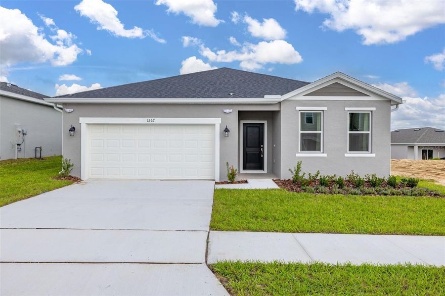 For Rent this beautiful brand new, never lived in Home with 4 bedrooms and 3 full baths. As soon as you walk in, find a long hall with decorative wainscoting wall panels. To the right find a junior master bedroom with a board and batten panel wall, walk in closet and a full bathroom with quartz countertop.  Entering the open floor plan; The kitchen is open and airy and features stainless steel appliances and blue backsplash. A large island compliments the space for meal preps and entertainment. The living room is ample and features vinyl plank flooring throughout all the wet areas and a ceramic TV wall with an installed bracket that can hold up to a 100in TV.  Sides decorative slat wood paneling. A covered patio to relax in the afternoons can be accessed from the living room. Generously sized primary suite with a unique paneling in navy blue and gold.  Large wall in closet.  The primary bathroom has a linen closet, dual sinks and an enclosed shower with a rain shower head. Laundry room with installed shelving for your detergents and clothes organization. Three additional bedrooms with a third bathroom make it ideal for growing families, all with board and batten pattern and different colors to go with your decor. This home has it all!  The landlord thought about every idea possible, including a water softener, decorative curtains, gutters, and a copper lightning rod to protect your family. Located minutes from Lake Eva Park and Ben W. Graham Park, the community offers a pool cabana, dog park, gazebo, walking paths and a playground.