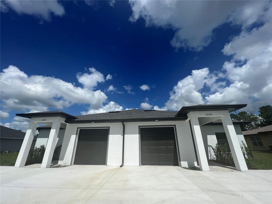 Brand new Panther Construction Luxury Villa just completed located in the heart of Deep Creek on a quiet street -- move in ready, no waiting necessary!  This spacious and modern duplex offers an excellent investment or low-cost living opportunity for the savvy buyer. Each side features 3 bedrooms and 2 bathrooms, providing comfortable living spaces for tenants or potential homeowners. With 1250 sq. ft. under air on each side plus under truss lanai and 9'4 high celings, there's plenty of room to accommodate different lifestyles. The total area under roof is 3,672 sq. ft.  The duplex is equipped with high-quality upgrades, including stainless steel appliances, 42" upper shaker cabinets and granite that add a touch of elegance to the kitchen. High end fixtures throughout the kitchen and bathrooms including ceiling fans.  The Luxury Vinyl Plank (LVP) Flooring throughout ensures easy maintenance and a contemporary look. Never worry about installing shutters from afar as Hurricane Impact Windows enhance safety and peace of mind during severe weather. The oversized garage features 8' garage doors (7' standard) which allows for a full size pickup to fit inside.  This villa is on city water and sewer.  The only available duplex in Deep Creek that is move-in ready will not last long!