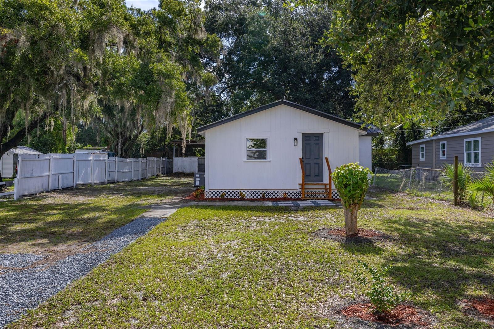 This charming and updated 3-bedroom, 1-bath home has been beautifully renovated with modern finishes. The interior features new laminate flooring throughout the main areas and bedrooms, while the bathroom boasts stylish tile flooring and a walk-in shower with matte black fixtures. Enjoy the comfort of a new hot water heater, washer and dryer hookups, and a brand-new kitchen equipped with white shaker-style cabinets with brushed nickel door pulls, alongside stainless steel appliances—including a refrigerator, stove, and microwave. Outside, you'll find a new back deck, a pole barn, and a storage shed, offering ample storage space. The property offers plenty of parking on the new gravel driveway and paver stone areas. Move-in ready for immediate occupancy—available for lease or purchase.