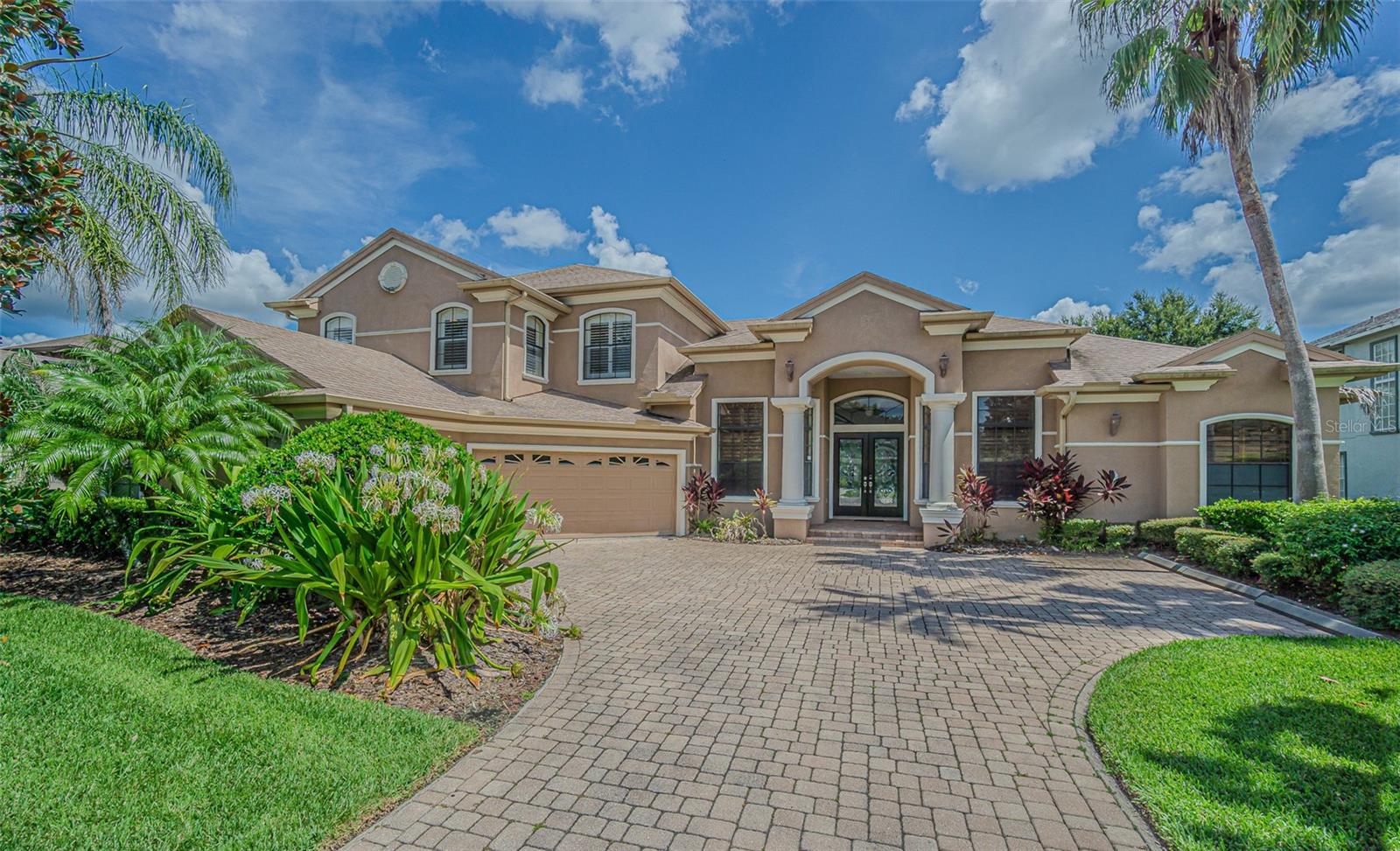 Step into the elegance of this semi-custom, former model Costanza home, perfectly situated in the private, gated enclave of Rose Pointe. This 5-bedroom, 3.5 bath luxury residence offers a blend of sophistication, comfort, and resort-style living – all fully furnished and move-in ready. On the main level, you’ll find a spacious primary suite with a cozy sitting area, custom his-and-her walk-in closets, spa-inspired bath with dual vanities, a soaking tub, and a stunning glass-enclosed shower. A guest en-suite, private office/den, and a light-filled bonus/sitting room surrounded by sliding glass doors complete the first floor. Upstairs, you’ll find two additional bedrooms, a full bath, a loft, and a versatile fifth bedroom or bonus space. The spacious kitchen boasts a custom 40" gas range, an island with abundant storage, 42" maple cabinets, breakfast bar, and a casual dining nook overlooking the pool. The open family room is warmed by a see-through gas fireplace flowing into a cozy bonus area, perfect for entertaining. Step outside to your heated pool and spa on an oversized, pavered lanai featuring a fully equipped outdoor kitchen. Nearly every room on the first floor opens to this outdoor oasis, creating the ultimate indoor/outdoor living experience. As a Rose Pointe resident, you’ll enjoy access to Club Connerton’s amenities, including a resort-style pool, cafe, fitness center, tennis and basketball courts, scenic walking trails, and a full calendar of community events. This exceptional home offers luxury, privacy, and convenience – all within one of Connerton’s most coveted gated neighborhoods.