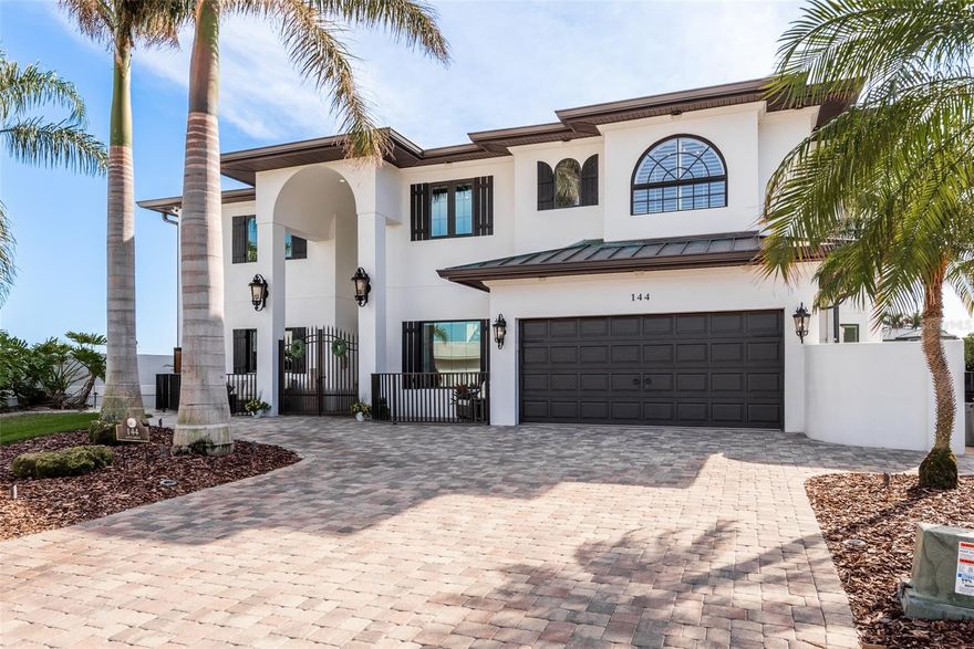 Welcome to 144 Aleta Drive in Belleair Beach, an award-winning masterpiece! Fall in love with INTRACOASTAL WATER VIEWS through every window and resort-living in your very own oasis! Be whisked away to this luxurious 5-bedroom, 4.5-bathroom, 4,662sf home totally renovated in 2020! From the curb, the ocean breeze wraps your senses and takes your breath away with the home’s modern design. Walking through the double-door grand entry, you’re welcomed by the sweeping staircase, high ceilings, elevator, elegant porcelain tile flooring, and a showstopping wine cellar capable of housing over 1,035 bottles while maintaining a perfect temperature. If this isn’t enough, the main level also boasts an in-law suite with the same incredible water views and an additional bedroom. The living room and kitchen combination accentuates the entertainment space, featuring breathtaking views of the Intracoastal waterway from upgraded windows and doors. Delight in every detail of this luxurious kitchen with elegant counters and extensive storage capabilities, including a walk-in pantry and a coffee/wine bar for your enjoyment. The kitchen also features an induction cooktop, built-in double convection ovens, a warming drawer, a trash compactor, an appliance garage, a microwave drawer, and more! The second-floor primary bedroom suite embraces you with a double door entry, allowing panoramic views of Belleair’s finest waterway that awaits to greet you every morning. The primary bathroom wraps you with a spa-like experience. There are two additional bedrooms coupled with their own full bathrooms and stunning views of the sparkling water. A bonus room is featured on this level, which could be a sixth bedroom, playroom, or media room as presented. Step outside to the second-level balcony and enjoy the sunset views! Bask in the sun and enjoy the resort life of the outdoor space featuring lush landscaping, a gas-heated pool with a jacuzzi, a covered patio area, beautiful accent lighting throughout the exterior, fully fenced, all naturally shaded by grand Florida royal palms—and a private dock with a boat lift capable of holding 8,500 pounds. Take delight in the Intracoastal waterway, views of the Belleair Causeway on the horizon, and pleasant sea breezes from the Gulf of Mexico. This location truly elevates the Florida lifestyle with privileged access to pristine white sandy beaches. Numerous updates include Roof (2021), HVAC (2020), Generac Generator (2022), Smart House/Security System, Solar Panels (2021), LED lighting throughout, updated dock, close proximity to Tampa International Airport, exceptional cuisine, shopping, and entertainment! This is truly a special home that awaits you!