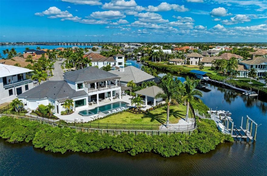 Experience the epitome of modern luxury living at the Reserve at Harbour Walk in a fully furnished distinctive residence featuring 4 bedrooms and 6 bathrooms across two captivating stories. Situated on an idyllic cul-de-sac waterfront lot, where four canals converge and open into the Manatee River, this home offers unparalleled lifestyle benefits. As you step through the grand two-story foyer, revel in the seamless flow of living spaces that connect the main living area, a spacious kitchen, and an inviting dining area. Indulge your culinary desires in the gourmet kitchen, equipped with top-tier Dacor appliances, a 6-burner gas cooktop with a dual oven range, and an expansive island featuring Cambria quartz countertops. The "disappearing corner" sliders extend the first floor to your private waterfront retreat-a 43' saltwater pool with an oversized sun shelf, cascading waterfall, and an 8-person spa. Complementing the pool is a complete outdoor kitchen under a 26x24 cabana, with a natural gas grill, two refrigerators, bar seating, and a separate dining table, accompanied by a tastefully designed pool bath and outdoor shower. An installed Mosquito Joe pest system enhances your outdoor living and dining. The property extends further to a private Trexx dock with a canopy covered 24,000 lb. boat lift, and dual jet ski floating platforms.
Inside, meticulous details abound, from custom-designed ceilings to a great room featuring a fireplace on the feature wall, seamlessly connecting to the gourmet kitchen and dining area-all with breathtaking views of the backyard resort. Wake up to awe-inspiring views in the first-floor owner's suite, designed for ultimate comfort and relaxation. This personal retreat includes custom his and hers walk-in closets and a spa-like bathroom with a separate soaking tub, an oversized dual-entry shower, and sliding glass doors leading to a luxurious private outdoor shower under a trellis. For added privacy, two secondary ensuite bedrooms on the first floor cater to guests or serve as an in-law suite. An elevator adjacent to the great room adds accessibility to the upper living area, and the first-floor powder room is accessible from both inside and out. Ascend to the second floor, where a bonus room with a wet bar awaits, complete with a microwave, wine cooler, ice maker, and dishwasher. Twelve-foot sliders in the bonus room open to a 15x40 balcony, offering unrivaled views of the surrounding canals and the backyard oasis. The second floor also boasts a fourth ensuite bedroom with sliders opening to the balcony. Additional features include a 4-car tandem garage with ample space for a golf cart or workshop. Whether you seek relaxation by the pool or aspire to entertain guests in style, this residence presents itself as a personal oasis for enjoying life's moments-from sunrise to sunset and beyond. Located in The Inlets, the Gulf Coast's premier gated waterfront community with deep water dockage, this home offers easy access to the historical districts of Bradenton, the cultural charm of Sarasota, and the excitement of Tampa and St. Pete. Live the dream in this exceptional residence that seamlessly blends sophistication with the joy of waterfront living.