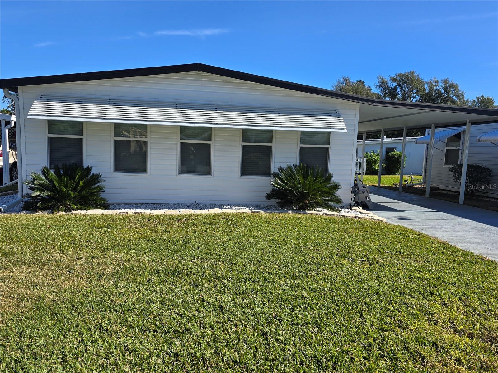 Don’t miss this incredible opportunity to own a charming, well-maintained home in the desirable Ariana Shores, a 55+ community! This cozy residence is ready for your personal touch, offering the perfect blend of comfort and potential. The spacious, airy living room is an ideal spot to relax, while the sun-soaked Florida room provides additional space for entertaining or simply soaking up the Florida sunshine.
The home features recent updates, including new windows and doors that bring in plenty of natural light, along with updated bathrooms, modern sinks, and fixtures for added convenience. The almost all new flooring (installed in 2020) flows throughout, creating a fresh, look. Plus, a newer refrigerator and a termite warranty provide added peace of mind, while the sprinkler system keeps your lawn lush all year round.
This property is part of a co-op, with each share valued at $30K, which is conveniently included in the sale price. Co-op living means you’re part of a close-knit, engaged community where residents have a voice in how the neighborhood is run. The community offers fantastic amenities such as a heated pool, shuffleboard courts, a fishing pier, and a boat ramp leading to the scenic Lake Arietta.
Make this move-in-ready gem your next home—schedule a showing today and seize this amazing opportunity!