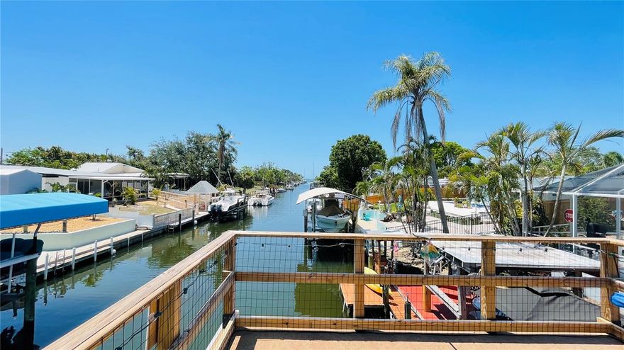Wake up to sunshine, step outside to waterfront breezes, and launch straight into the boating life from this eclectic canal-front home. Three things you won’t want to miss: 1. HIGH AND DRY, no flood insurance required; 2. SAILBOAT WATER 5 MINUTES FROM SARASOTA BAY; and 3. MARINA and waterfront amenities exclusively available for Bayshore Gardens included in the tax bill! THE HOUSE: Start with the low maintenance no-mow yard and walk through the roughly 1800 square feet of air-conditioned space right out to the enormous covered and screened living area wrapped around the pool. Go down the path to the canal-side tiki bar and boat lift with elevated observation deck offering glimpses of Sarasota Bay. There is so much to love here, accumulated and assembled by the owner of 17 years. SEE ATTACHED OWNER NOTES AND FAQ for details. The boat, a 22-foot, 150 HP Pro-Line cuddy on the lift is included in the sale, along with the outdoor covered Jacuzzi with dedicated water heater. Other furnishings and extensive decorations could be negotiated on a separate bill of sale. The house has stood since the 50s, above the flood plain, and has remained high and dry, season after season. Comfort is the key and the owner has added numerous features for easy living, including a dockside entertaining area with water, power, cable tv, a covered tiki bar, fish cleaning station, and seating area. Atop the boat lift is a permitted, custom 12 x 13 roof and deck with railing for catching views of the bay and islands. There is a lower dock for launching kayaks and loading the boat for the day’s adventures. A short trip down the canal and you are loose on open Sarasota Bay in less than 5 minutes – one of the best bay-access canals anywhere in the area. Other features too -- like extensive landscape lighting, for example -- too numerous to list can be found in the attached documents. Note that the seller is willing to negotiate private financing and will not require flood insurance. This home is located within the Bayshore Gardens Park and Recreational District, with clubhouse, pool, boat ramp and marina (at discounted rates not available to the general public), waterfront park with fishing pier and kayak launch. Boaters and water-lovers hurry, 409 Bryn Mawr Island has it all, all ready for you to start your Florida boating life today!