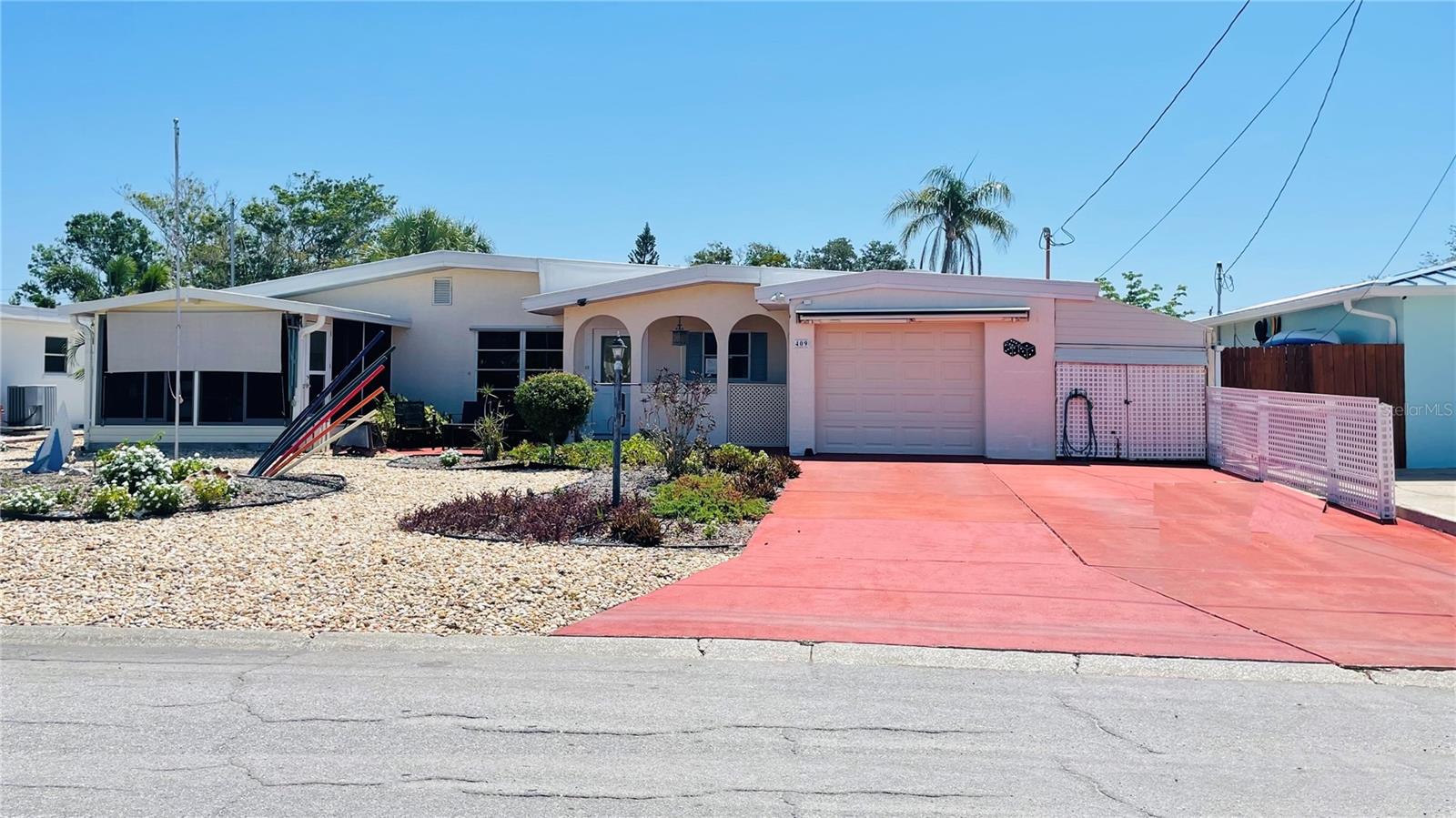 Looking for the complete Florida outdoor living and boating experience? This sprawling canal front ranch style home is the one! OWNER FINANCING available with NO flood insurance required. Start with the low maintenance xeriscaped yard and walk through the roughly 1800 square feet of air-conditioned space right out to the enormous covered and screened living area wrapped around the pool. Go down the path to the canal-side tiki bar and boat lift with observation deck offering glimpses of Sarasota Bay. There is so much to love here, accumulated and assembled by the owner of 17 years. The boat, a 22-foot, 150 HP Pro-Line cuddy on the lift is included in the sale, along with the outdoor covered Jacuzzi with dedicated water heater. Other furnishings and extensive decorations could be negotiated on a separate bill of sale. The house has stood since the 50s, above the flood plain, and has remained high and dry throughout. Comfort is the key and the owner has added numerous features for easy living, including a dockside entertaining area with water, power, cable tv, a covered tiki bar, fish cleaning station, and seating area. Atop the boat lift is a custom 12 x 13 roof and deck with railing for catching views of the bay and islands. There is a lower dock for launching kayaks and loading the boat for the day’s adventure. A short trip down the canal and you are loose on open Sarasota Bay in less than 5 minutes – one of the best bay-access canals anywhere in the area. Other features too -- like extensive landscape lighting, for example -- too numerous to list can be found in the attached documents. Note that the seller is willing to negotiate private financing and will not require flood insurance. This home is located within the Bayshore Gardens Park and Recreational District, with clubhouse, pool, boat ramp and marina (at discounted rates not available to the general public), waterfront park with fishing pier and kayak launch. Boaters and water-lovers hurry, 409 Bryn Mawr Island has it all, all ready for you to start your Florida boating life today!