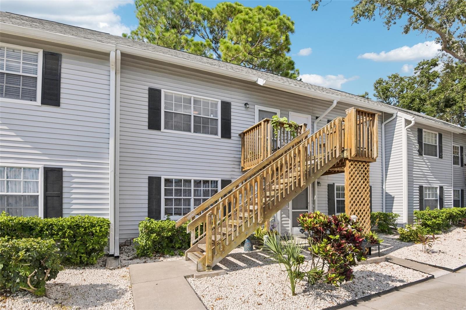 Don’t miss this fantastic opportunity to own a charming 2-bedroom, 1-bath two-story condo just minutes from the beach in the all-ages, pet-friendly Manor Condo community! This well-maintained unit features a master bedroom and bath on the main floor, a spiral staircase leading to a loft and second bedroom upstairs, ample closet space, and a screened balcony with extra storage. Recent updates include a new roof (2025), HVAC (2023), water heater (2022), fresh interior and exterior paint, and wood flooring with a kitchen refresh. The community offers resort-style amenities including a pool, hot tub, tennis courts, and racquetball, and the location is unbeatable—close to Gulf beaches, shopping, dining, Tampa, and downtown St. Petersburg. Bonus: this condo has never lost power during hurricane season, offering added peace of mind! Don’t miss this ONE — schedule your showing today!