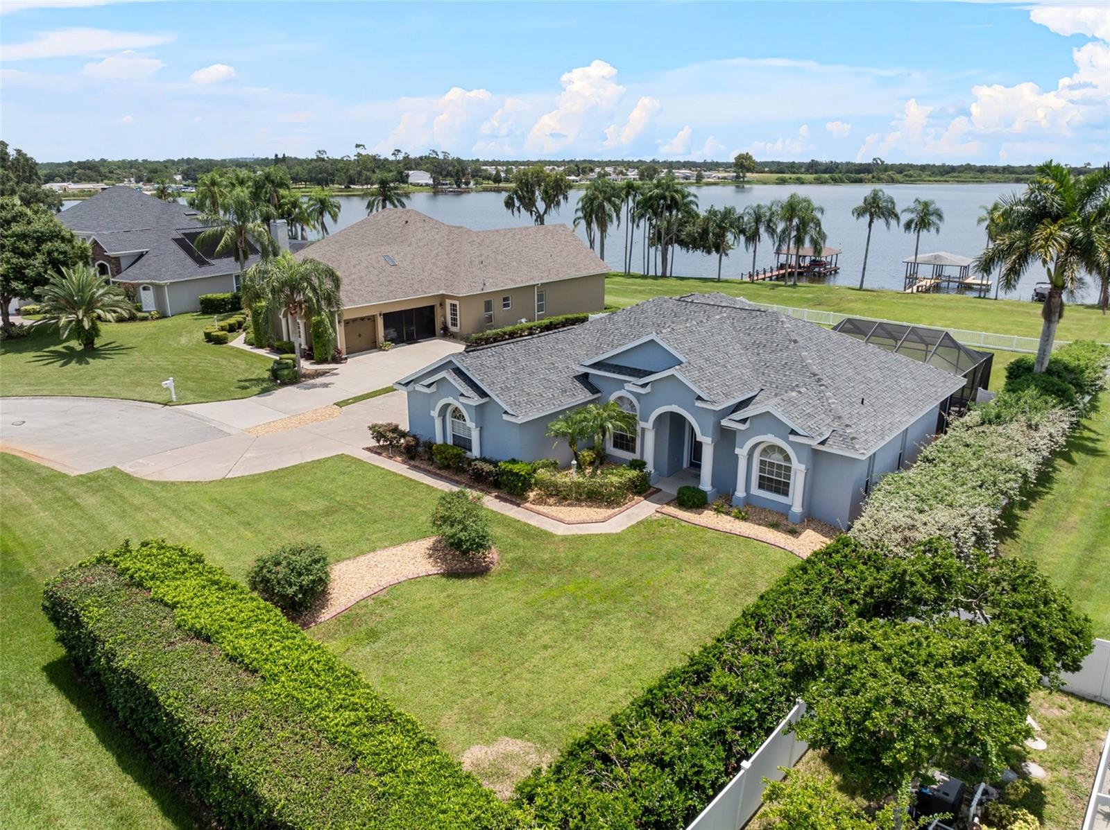 *EXCLUSIVE SHORT-TERM RENTAL available from NOW to April 15, 2026.* Welcome to this stunning lakefront pool home in the gated community of Miller's Landing. Situated on a 0.80-acre lot, this property features a private geothermal pool, newly built dock with a boat lift, oversized fenced/gated backyard, well irrigation, 3-car garage, LVP flooring throughout, and crown molding. Upon entering, you're greeted by a beautiful foyer that leads to a formal living room with views of the pool and Lake Bess. The spacious chef's kitchen boasts granite countertops, a breakfast bar, ample cabinetry, Samsung appliances, and a gas range. The kitchen opens to a dinette, with picture window showcasing more gorgeous views, and flows into the cozy family room. Entertaining is an ease in this home, with four access points to the screened-in pool. Adjacent to the foyer and kitchen is the formal dining room. The primary bedroom features dual walk-in closets, a walk-in tile shower, split his-and-her granite vanities, a jetted garden tub, and a private water closet. The split bedroom plan places the other two generous bedrooms off the family room, with a hall bath with a tub/shower between them. Laundry room equipped with washer and dryer including extra cabinets for storage. Enjoy relaxing, barbecuing, and entertaining by the pool, complete with the convenience of a dedicated pool bathroom. Experience wonderful lake days on Lake Bess, with canal access to Lake Ruby. Located minutes away from shopping, Walmart, Publix, restaurants, Legoland, and quick access to HWY 27 heading to Orlando/Tampa. Don't let this one slip away, call today!