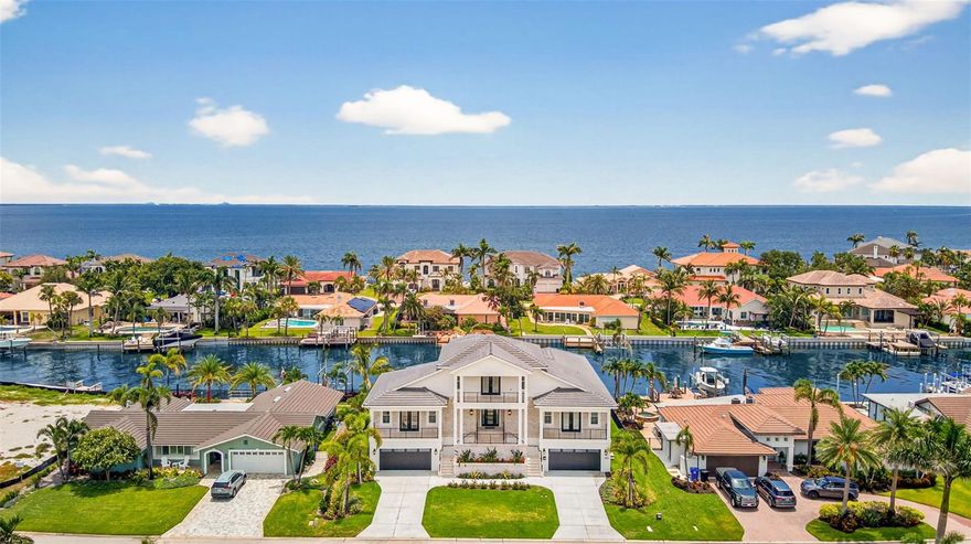 One or more photo(s) has been virtually staged. A dream opportunity can become your reality. Newly constructed custom home completed in 2025 extends an elevated experience to waterfront living. 4,317 under-roof living square footage encompassing 5 large bedrooms plus an office, 4.5 bathrooms, 8-car garage, and breezy balcony with views of Downtown Tampa. The moment you enter through the front door, you will be captivated by this coastal masterpiece with 10-foot ceilings, an abundance of natural lighting, beamed ceilings, and a kick back, relax, and stay awhile vibe. The custom design with front and rear French doors allows you to open the house up for a phenomenal crossbreeze or when entertaining and utilizing the indoor/outdoor living. The kitchen features a large island with a large prep sink, bar seating, a beverage station, a gas range, and overlooks the spacious living room with access to a large balcony overlooking the pool and spa area. Enjoy formal meals in the dining space with convenient access to the butler's pantry, which can be closed off and out of sight but contains storage, a second full-size dishwasher, and space for a large wine or full-size second refrigerator. The split floor plan extends 3 bedrooms and 2 bathrooms on one side of the house. Guest powder bathroom, private office, and a Jr primary suite are also on the main level. Jr primary suite overlooks the water and pool with balcony access. En-suite large bathroom with walk-in shower and walk-in closet. The second-level living is designed to work as needed. This space extends to a spectacular primary bedroom with a reading nook, breakfast/coffee bar, and an impressive en-suite bathroom. The second-level balcony is the perfect place to relax, enjoy an evening breeze, or watch the sunrise in the morning. Year-round fish in your backyard, and watch the dolphins or manatees play. Brand new beautiful pool with spa, substantial new raised seawall, and green space for kids or pets. The property can accommodate a very large deep vessel or dock. Canal offers protection and unobstructed direct access to Tampa Bay. Conveniently located with proximity to top-rated schools, shopping, and one mile from the upscale neighborhood market. Kayak or paddleboard from your backyard to Weedon Island Preserve. Access Downtown St Petersburg by boat, golf cart, or even a bike ride, only 4 miles away. 25 quick minutes to our world-famous Beaches, 2 major international airports, and Albert Whitted private airport. Venetian Isles is an exceptional deed-restricted neighborhood with an optional HOA.