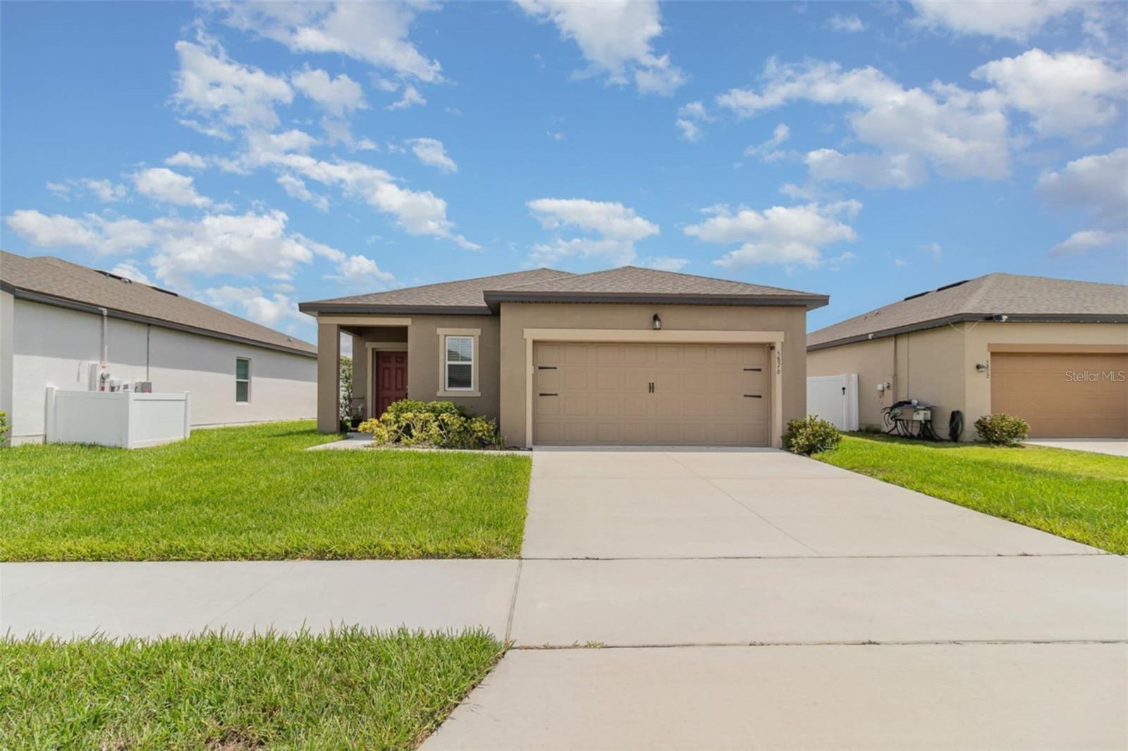 One or more photo(s) has been virtually staged. Welcome to 5876 Bovine Dr – a clean, well-maintained 3-bedroom, 2-bathroom home located in the desirable Sunbrooke community of St. Cloud. This move-in-ready home offers a functional open floor plan with neutral finishes, making it easy to personalize and make your own.
The kitchen features an upgraded backsplash, stainless steel appliances, and a center island that opens to the dining and living areas—perfect for everyday living or casual get-togethers. The primary suite includes a walk-in closet and en-suite bath with double sinks and a walk-in shower, while the two additional bedrooms offer flexibility for guests, family, or a home office. Step outside to enjoy the screened-in covered patio, ideal for relaxing outdoors without the bugs. The backyard is open and ready for whatever you envision—gardening, play, or entertaining. This home comes with a water softening system and double osmosis filtration system in the kitchen. Located in a quiet community with no CDD, low HOA fees, and access to great amenities like a pool, clubhouse, fitness center, and playground. Just minutes from Lake Nona, Medical City, and major highways, this home offers comfort and convenience in one of Central Florida’s fastest-growing areas.