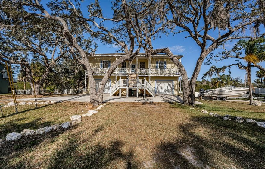 Welcome to 5127 Bay Blvd, Port Richey, FL 34668, a waterfront home for sale in Port Richey with Gulf access, a saltwater canal location, and the space and flexibility buyers are looking for in a true Florida coastal property. This Key West-style home offers 4 bedrooms, 2 full bathrooms, 1 half bath, and 2,162 square feet, all set on an oversized 0.48-acre lot with room for boat parking, RV parking, and multiple vehicles.

Inside, this Port Richey waterfront home features an open floor plan, high ceilings, a split-bedroom layout, tile and laminate flooring, and a wood-burning fireplace. The spacious layout offers comfortable everyday living, room for guests, and flexible options for buyers searching for a primary residence, vacation home, waterfront retreat, or investment property in Port Richey.

Step outside and enjoy the features that make Florida living worth the electric bill — expansive porches, a screened porch, private deck, fire pit, and waterfront views. This property also includes a private boat ramp for small watercraft, making it a standout for buyers searching for a boat-friendly home in Port Richey, a canal home with Gulf access, or a waterfront property near the Gulf of Mexico.

The lower level includes dual garages and a bonus flex space with a private entrance, ideal for a guest suite, in-law space, home office, home gym, or hobby area. Buyers looking for a multi-generational home in Port Richey or a property with extra usable space will appreciate the versatility this home offers.

Located in the Martha's Vineyard waterfront community, this home is close to marinas, parks, dining, shopping, and Downtown New Port Richey. If you are searching for a waterfront home in Pasco County, a Gulf access home in Port Richey, a Florida home with boat parking, or a coastal home with flexible living space, 5127 Bay Blvd is a property you need to see.