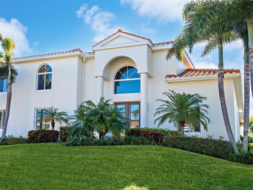 Rarely available in the highly desirable Boating and Beach Community of Country Club Shores on South Longboat Key. This stunning home is just one in from the bay with amazing Sarasota Bay views, south facing providing excellent natural light all day, with 113 feet of waterfront and deeded beach access just across Gulf of Mexico Drive. An open floorplan with a full renovation of the interior and exterior completed in 2021, this amazing above the flood plain home offers five bedrooms with a den/office, elevator, gourmet chef’s kitchen, three en-suite bedrooms, mud room, expansive laundry room with amazing storage and a second refrigerator, additional laundry facility in the primary bedroom, designated gym, half pool bath, impact windows and a wall of glass sliders opening up to a spectacular outdoor experience that is a must-see!  The three-car oversized garage provides access to the pool and dock with storage for kayaks, bicycles, and all your beach and boating needs plus a natural gas generator to provide peace of mind. The extensive list of upgrades and designer finishes include a Thermador natural gas double oven with six burners and a side induction burner, microwave drawer, three wet bars throughout the home, wine refrigerator, Sub-Zero main refrigerator plus freezer and refrigerator drawers, designer ceiling fans and lighting, Sonos audios system with whole home speakers, and beautiful coastal all porcelain plank tile floors on the main level leading to engineered hardwood floors throughout the second floor. You cannot find a better outdoor entertaining area which offers a full outdoor kitchen, natural gas grill with side burner, power LED lighted awning with wind sensors providing additional shade, infinity pool and 10-person jacuzzi with safety features both of which can be heated by natural gas or electric and includes a chiller, outdoor shower, travertine floors, LED step lighting leading to a new composite expansive dock with a 16,000-pound lift, kayak launch, snook lights and fish cleaning station. There is an additional large open composite second floor deck as well as a private primary suite balcony both providing stunning sunrise views of the Bay. This home has it all! Country Club Shores is the ideal location providing walking or biking access to golfing, tennis, the beautiful and secluded sands of Longboat Key and the amazing shopping and dining of St. Armands Circle. With deep sailboat water, and just a short distance to New Pass and the Gulf of Mexico, this home ends your search for the ideal waterfront home.