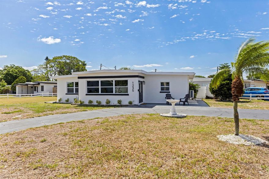 Your dream home just hit the market! This fully renovated and permitted 3-bedroom, 2-bathroom BLOCK home sits on an oversized lot in the highly desirable Disston Heights neighborhood and offers standout curb appeal with fresh exterior paint and a massive circular driveway. Located in a NON-flood zone, this property provides both peace of mind and exceptional outdoor space. Inside, the home shines with fresh interior paint, luxury vinyl plank flooring, abundant natural light, and a spacious open layout. Vaulted ceilings add character and enhance the airy feel of the main living areas. A well-designed split floor plan offers privacy, with two bedrooms and a beautifully updated guest bathroom on one side and a generous primary suite on the other. The primary en-suite bathroom is a true highlight, featuring a fully renovated design with a beautifully tiled walk-in shower. Designed for both everyday living and entertaining, the home offers multiple living spaces, including two inviting living rooms—one with bar seating—and a dedicated dining area. The stunning kitchen features quartz countertops with bar seating, soft-close two-tone wood cabinetry, a stylish backsplash, and new stainless steel appliances. Major recent and newer updates include a 2024 roof, 2021 AC, 2026 water heater, 2026 mini split, newer plumbing, and newer windows—making this home truly move-in ready. Step outside to your private backyard oasis with plenty of space for a boat, RV, or future additions. Ideally located just minutes from downtown St. Petersburg, Gulfport Arts District, and the Gulf Coast’s beautiful beaches, you’ll enjoy quick access to top dining, shopping, nightlife, and entertainment while still being tucked away in a quiet, established neighborhood. Centrally located yet peacefully set, this home offers the best of both worlds. Schedule your showing today—this one shows beautifully and won’t last.