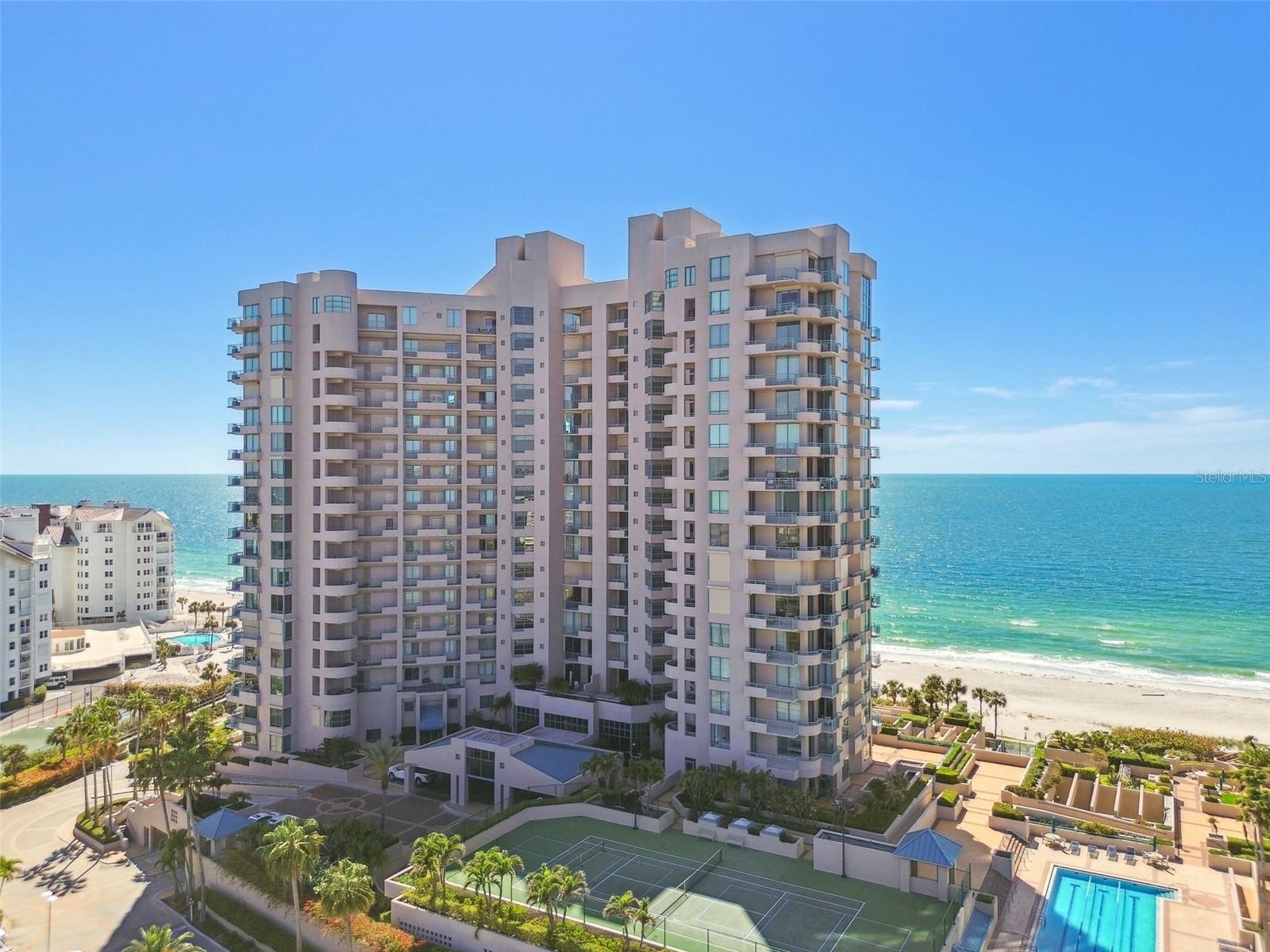 Discover the pinnacle of beachfront opulence at this completely renovated, two-story Plaza level residence on Clearwater Beach/Sand Key Beach. This rare corner unit offers an unrivaled lifestyle, boasting over 4,300 square feet of meticulously designed indoor space seamlessly connected to more than 2,500 square feet of expansive outdoor living. Imagine basking in the breathtaking Gulf views from your private, wrap-around terrace and balconies, creating an idyllic setting for relaxation or entertaining.
Step inside to a world of refined elegance, where every detail has been curated for the discerning. Revel in the luxury of new interior finishes throughout, including exquisite marble and tile flooring. The direct water access, coupled with three outdoor pools and the pristine beach just steps from your door, defines the ultimate resort-style experience. Ultimar III on Sand Key Beach sets the standard for 5-star resort living at its finest with 3 pools, fitness center, tennis, basketball court, putting green & more!
The open and spacious floor plan, with its soaring ceilings and designer lighting, creates a warm and inviting ambiance. This exceptional residence features four bedrooms and 3.5 baths, offering ample space for family and guests. The gourmet kitchen is a culinary dream, equipped with beautiful stone countertops, high-end stainless steel appliances, a spacious pantry, and a convenient breakfast bar.
Retreat to the tranquil primary suite, a private sanctuary complete with a Gulf-front balcony, a generous sitting area, and a spa-inspired bath. Indulge in the luxury of two separate vanities, double walk-in closets, a jetted tub, dual water closets, and an oversized steam shower. All secondary bedrooms are thoughtfully situated on the second level, each offering captivating views and private balconies – perfect for savoring Florida's spectacular sunsets. *Home is also listed for sale