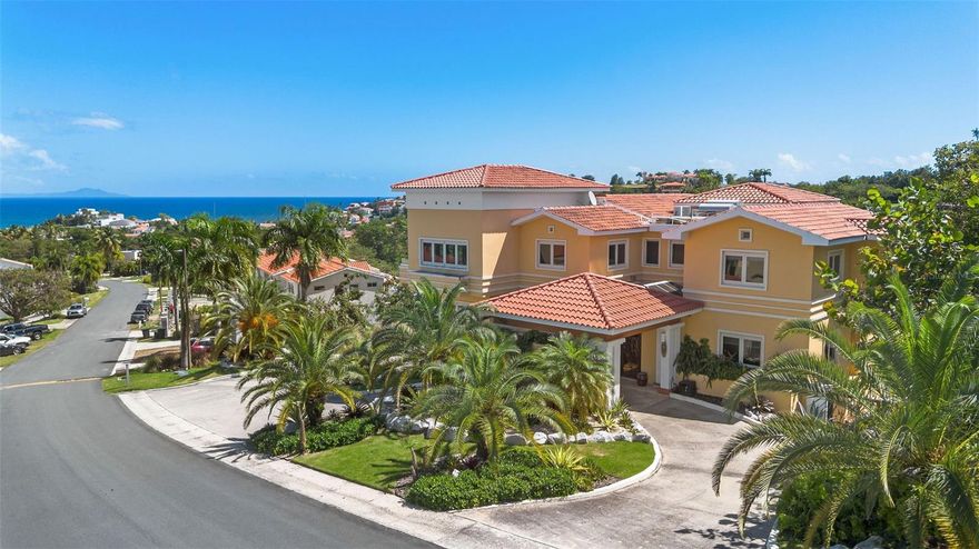 One or more photo(s) has been virtually staged. One or more photos have been virtually staged. Experience elevated coastal living in the heart of Palmas del Mar, where luxury, space, and breathtaking ocean and marina views converge. This exceptional residence offers over 5,380 interior square feet and has been meticulously renovated to high-end standards, delivering a truly move-in-ready lifestyle in one of Puerto Rico’s most sought-after resort communities.

Designed for both refined daily living and effortless entertaining, the home features five generously sized bedrooms plus a dedicated office, including a first-floor bedroom and full bath—ideal for guests or multigenerational living. Expansive living areas are filled with natural light, while large windows frame sweeping ocean sunrises and unforgettable marina sunsets.

At the center of the home, the fully renovated chef’s kitchen blends style and functionality, flowing seamlessly into open living and dining spaces. A private movie theater offers the perfect setting for relaxed evenings or entertaining at home.

Thoughtful upgrades include solar panels, a 20k diesel generator, and quality finishes throughout, enhancing both comfort and long-term efficiency. Outdoor spaces invite year-round enjoyment, complete with a fire pit ideal for evening gatherings.

Located within Palmas del Mar, residents enjoy access to championship golf courses, marinas, beaches, dining, shopping, and resort-style amenities, all within a secure, master-planned community.

Additional Highlights:
Over 5,380 interior sq ft
5 bedrooms + office
Private movie theater
Renovated kitchen
Ocean and marina views
Solar panels + 20k diesel generator
Fire pit
Garage plus driveway parking for up to 6 vehicles
HOA: $1,300/year

This is a rare opportunity to acquire a fully renovated luxury residence offering exceptional value, scale, and lifestyle in Palmas del Mar.