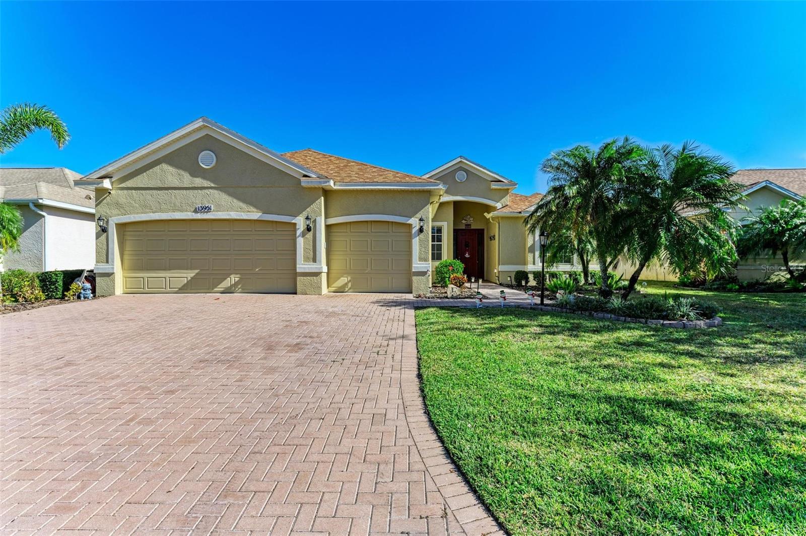 Welcome to a showstopping residence where upscale design and effortless living come together in one of Lakewood Ranch’s most desirable locations. This exquisite home showcases a seamless open-concept layout filled with natural light, elevated by rich wood-look tile flooring, a soft neutral color palette, and designer finishes throughout. At the center of the home lies a chef’s dream kitchen, complete with a gas range, solid wood cabinetry, quartz countertops, stainless steel appliances, touchless faucet, and a built-in glass rinser. The kitchen flows effortlessly into the spacious dining area and a welcoming living room anchored by a stunning stone fireplace—perfect for gathering with family and friends. The split-bedroom floorplan offers exceptional privacy, with three generously sized guest bedrooms and a beautifully remodeled pool bath on one side of the home. The luxurious primary suite offers pool and lake views, a cozy sitting nook, dual walk-in closets, and a spa-inspired en-suite bathroom featuring quartz counters, LED mirrors with adjustable lighting, an oversized walk-in shower, and a soaking tub for ultimate relaxation. Every bathroom has been updated with quartz counters, frameless glass showers, and smart toilets with built-in bidets. Designed for seamless indoor-outdoor living, sliding glass doors lead to an expansive screened-in lanai overlooking tranquil lake views and a solar-heated pool—your private oasis for relaxing or entertaining. Recent upgrades include brand new lanai decking (2025), no-see-um screens (2023), a new roof (2020), and a full interior remodel completed between 2021–2022. The oversized three-car garage features a mini-split A/C system, new garage door motors, and epoxy-coated flooring. Additional features include a central vacuum system and high-efficiency systems throughout. Located just minutes from I-75, top-rated schools, Adventure Park, Waterside Place, and University Town Center, this home offers unmatched convenience and access to premier shopping, dining, and entertainment. With style, space, upgrades, and location, this home truly checks every box. Schedule your private showing today and experience luxury living at its finest.