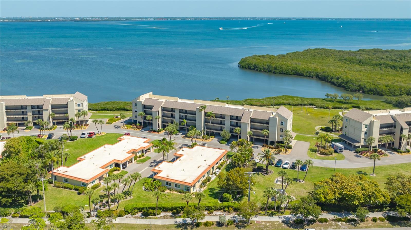 AMAZING BUYER BONUS! MOTIVATED SELLER IS OFFERING TO PAY THE REMAINDER OF 2025 MONTHLY ASSOCIATION DUES FOR THIS BRAND NEW BEACH & BAY VILLA! (At closing, with accepted contract.) Renovated with precision, the final finishing touches were completed March 26, 2025 for this quality engineered, down to the studs, two-bedroom and two-bath beach getaway villa. From the moment you step inside, you'll be greeted by a thoughtfully designed sunny open floor plan boasting recessed lighting and an array of sleek finishes throughout the home. Distinguishing features include the true craftmanship of custom solid core doors, chic beach themed door and cabinet knobs, custom designed laundry closet housing a Full-sized front load Samsung washer & dryer, self-close solid kitchen cabinets with a bonus spice rack cabinet, pull out shelves in the pantry and below the sink, ceramic floor tiling through-out including a curb less shower entry located in the primary suite’s “ensuite bathroom. The pièce de résistance is the Cambria Quartz (lifetime warranty) kitchen countertop chosen for the beach inspired aqua accents that showcase both a breakfast bar and a dual temperature wine/beer refrigerator for added pleasure. The second bedroom is cleverly designed to serve as both an office and a guest space, complete with a comfortable “guest chest” Murphy bed cabinet. For peace of mind while away, the villa is equipped with the latest Wi-Fi enabled keyless smart lock entry system, as well as a smart remote thermostat to monitor and manage remotely. Worry free living with a New A/C (2022), Water Heater (2024) and recent Hurricane Impact Windows/Sliding Doors, Roof, & Carport (2020). Located directly across the street, with 3 beach access points (one private deeded) is the tranquil Gulf with its crystal-clear turquoise blue waters and uncrowded sandy beaches that attract visitors from all over the world. A low-density residence and a nature lover’s delight: from captivating bird watching to the frolicking dolphins and manatees of Longboat Key. Windward Bay's unparalleled amenities include 2 tennis/pickleball courts, 2 marinas with 28 boat & jet ski slips for a low monthly fee (first come first served), barbecue grills throughout, fishing piers, 2 fish cleaning stations, kayak racks, 2 heated pools, shuffleboard, bike racks, a clubhouse with kitchen, library, fitness room, meeting room, 2 saunas, and community fire pits throughout the property. Conveniently accessible to Downtown Sarasota, St. Armands Circle, Anna Maria Island, Historic Cortez Fishing Village, Championship Golf Courses, renowned restaurants, shopping destinations, and vibrant cultural attractions, you'll never have a shortage of entertainment options. Welcome home to “Pet Friendly” Windward Bay, where TWO pets are allowed. Windward Bay is a financially healthy Condo Association with a proactive Board. The Milestone Inspection and Capital Reserve Study are complete and Monthly Condo Fees for 2025 were actually reduced. This wonderful condominium exemplifies “Florida Gulf to Bay Living” at its finest. Windward Bay: "A Special Place and A Gem of a Community." Whether you're looking for a vacation home or a permanent residence, book your private showing today. Longboat Key and Villa 7 in Windward Bay offer everything you could desire to live the life you have always dreamed of!