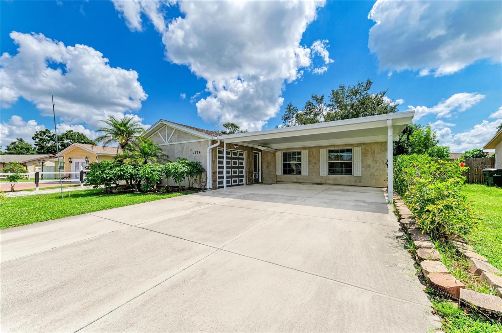 One or more photo(s) has been virtually staged. Charming Sarasota home on .21 acres – minutes from Gulf Coast beaches! NO HOA, NO FLOOD ZONE (Zone X). This 3-bedroom, 2-bath home features 1,164 sq. ft. of thoughtfully designed space with custom tile, travertine, and stone masterfully crafted. Enjoy peace of mind—ROOF, A/C, and WATER HEATER(2022) are less than 6 years old. The front exterior has 3/4" travertine tile on the house, along with custom tile on the walls in the primary bed and bathroom. The guest bath is tastefully updated with beautiful decorative ceramic tile! There's ample room for RVs, campers, motorcycles, or boats. Step outside to a FULLY FENCED backyard ready for relaxation and fun. Two sheds provide storage—one equipped as a workshop with electricity, the other for tools or lawn equipment. The tiki bar creates the perfect scene for entertaining or unwinding in your private retreat. The three-car carport protects your vehicles from the weather. The attached one-car garage includes a workbench and excellent lighting, ideal for projects. With major updates complete, this home is move-in ready. Enjoy easy access to parks along Sarasota Bay for sunsets, fishing, or launching paddleboards and kayaks. Nearby cultural attractions include the Ringling Museum with events, and Asolo Theatre, home to Asolo Rep and Sarasota Ballet. Downtown Sarasota and the Sarasota Bradenton Airport are a 5-minute drive, while St. Armands Circle and Lido Beach are just 10 minutes away, and short walk to E.D. Smith stadium home of the Baltimore Orioles! Experience the best of Florida living in this beautifully remodeled home in Green Manor Estates. Whether you seek a family retreat or investment, this well-maintained home is ready for you.