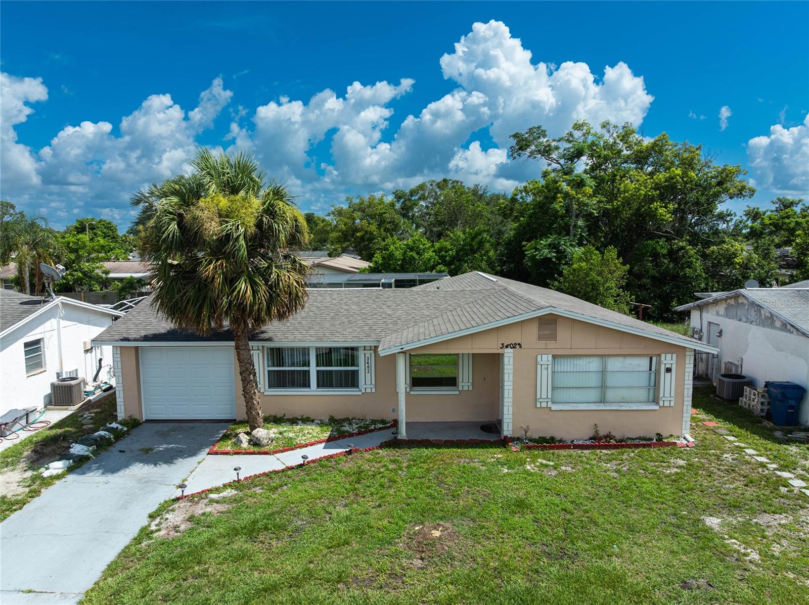 PRICED TO SELL!! This beautifully updated 3-bedroom, 2 bath with AN IN-GROUND POOL,1 Car garage home is light, bright, and full of opportunity located in Aloha Gardens Community is looking for its next owner! this stunning home is sure to be perfect for any first-time home buyer or real estate investor. The Main Room has a Walk in Closet, the other two rooms have a large closet. Living Room, Dining Area with a center kitchen opening to the Family Room. French doors from the Family Room open out to the spacious pool area. A screen-enclosed pool with a sweet backyard patio area makes this home perfect for those summer pool parties. Step outside to your private paradise! NEW ROOF 2025 ! New pool pump and vacuum cleaner! Electrical panel Update 2022! , AC 2017. NO HOA,NO CDD,NO SEPTIC TANK IS PUBLIC SEWER, Seller ARE NOT currently required to have flood insurance ! Close to shopping, restaurants, and some of Florida's top-rated Beaches! Easy commute to Tampa, Clearwater and St. Petersburg! Only a few minutes away from the Historic Tarpon Springs Sponge Docks! The lot is located in a Flood Zone code X