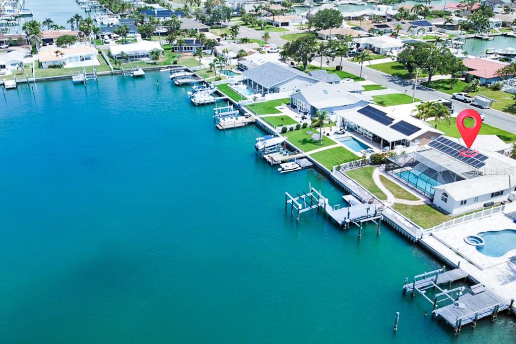 Under contract-accepting backup offers. Welcome to 11900 7th Street E, a prime waterfront property located in the sought-after Capri Isle neighborhood of Treasure Island. Set on a 75-foot-wide protected canal with deep sailboat water access, this home is just minutes to the Gulf via world-famous John’s Pass, offering an unbeatable lifestyle for boaters and water enthusiasts.
The home includes a permitted addition that expands the living area with a bonus family room and a flexible 4th bedroom/office/bath suite, offering privacy for guests or a separate retreat. The split-bedroom layout enhances functionality and flow, while the home’s layout allows for a seamless indoor-outdoor connection.
Relax and entertain outdoors year-round under the extra large birdcage-style screened enclosure and covered lanai, overlooking the solar-heated large saltwater pool which was resurfaced in 2017 along with the surrounding deck. The generous outdoor space offers ample room to enjoy the peaceful, shaded surroundings.
Inside, the chef’s kitchen boasts solid granite countertops and a suite of newer appliances, including an induction cooktop. The washer, dryer, and A/C system are also newer, providing important functional value.
This home is equipped with owned solar panels installed in 2019, delivering huge monthly savings on electric bills. An energy-efficient bonus for long-term living or investment.
Positioned on a spacious lot, the property features two boat lifts, One configured for a sailboat, the other for a small craft or jet skis, as well as a floating kayak dock, all surrounded by newer Trex decking for long-lasting durability. This is true deep water on the Intracoastal Waterway, ideal for those with larger vessels and a passion for the water.
The property sits on a quiet street with no through traffic, providing privacy while still being close to everything. You're just a short stroll or bike ride to Treasure Island’s sandy beaches, and only minutes from John’s Pass Village & Boardwalk, where you’ll find restaurants, shopping, fishing charters, and live entertainment. With exceptional boating water, solid infrastructure, and a rare chance to create your own vision, this is a compelling opportunity in one of Pinellas County’s most beloved coastal communities.
Please note the property sustained flood damage during Hurricane Helene in 2024 and has not been renovated to current Pinellas County building codes. It is being sold strictly as-is, with no repairs or credits to be provided by the seller. The home remains structurally intact and presents an outstanding opportunity for buyers interested in renovation or new construction in a prime waterfront location.
Don’t miss out, opportunities like this are rare. Schedule your private showing today