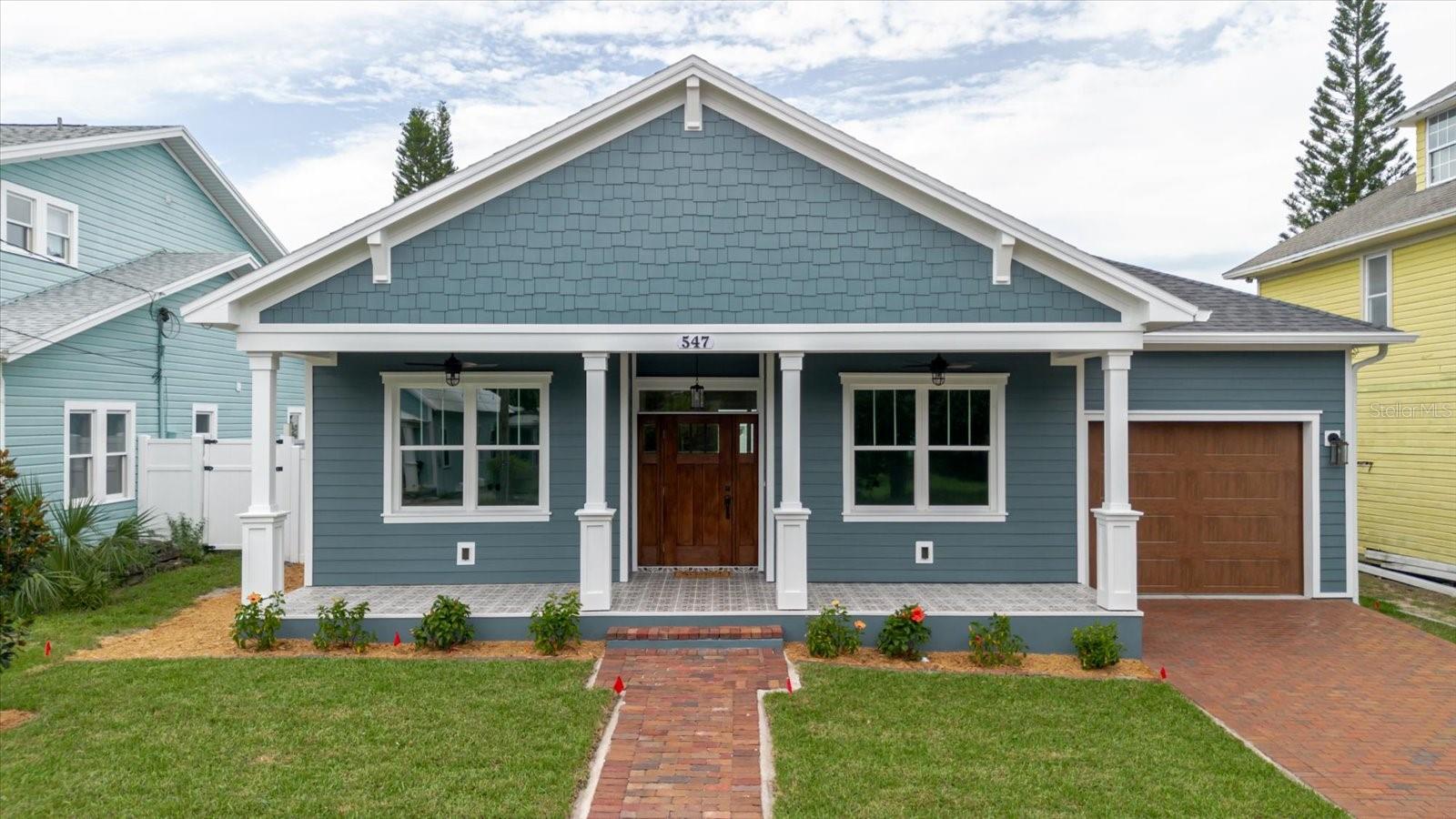 One or more photo(s) has been virtually staged. Welcome to this brand-new 3 bedroom, 2 bath craftsman-style home with an oversized 1-car garage, perfectly situated in Tarpon Springs’ historic “Greek Town” district. Just steps from the world-famous Sponge Docks, Downtown, the Bayou, Pinellas Trail, splash park, dog park, pickleball courts, marinas and more – this location is truly unbeatable.
Built for peace of mind, this single-story block home sits at a finished floor elevation of 19 feet above sea level and is not in a flood zone. All windows are impact rated, as well as the high-lift garage door.
Inside, you’ll find upgrades throughout: soaring ceilings, crown molding in every room, custom wood window casing and sills, 8-foot doors, and high-end luxury vinyl plank flooring. The family room showcases a stunning custom woodwork surround with a traditional electric fireplace, while the dining room features elegant wainscoting and a niche with sconces matching the beautiful chandelier.
The custom kitchen includes solid wood cabinetry, granite countertops, glass display cabinets, and a wine/beverage fridge, with an eat-in space and an island perfect for casual meals. An inside laundry room with utility sink and cabinetry adds convenience.
Enjoy outdoor living on the large tiled front porch overlooking the red brick street or in the fenced backyard with pavered patio and tiled porch – perfect for relaxing or entertaining. Both front and back porches boast custom stained wood ceilings and ceiling fans. Additional highlights include a pavered driveway, ample storage in the oversized garage, sprinkler system, and prewiring for security cameras and outdoor spa.
With its prime location, elevated construction, and modern upgrades, this home is a rare find in Tarpon Springs.