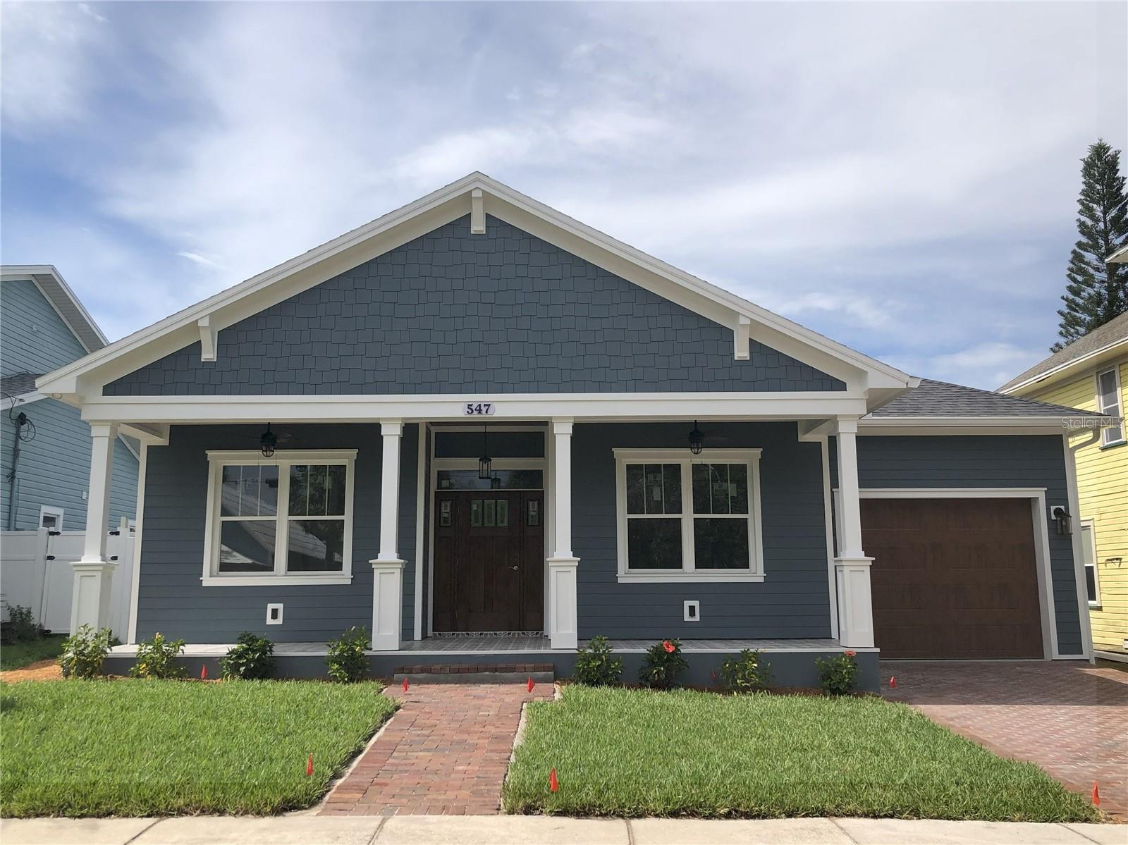 Under Construction. Under construction, expected completion by 8/31. Pictures coming soon! Welcome to this brand-new 3 bedroom, 2 bath craftsman-style home with an oversized 1-car garage, perfectly situated in Tarpon Springs’ historic “Greek Town” district. Just steps from the world-famous Sponge Docks, Downtown, the Bayou, Pinellas Trail, splash park, pickleball courts, and more – this location is truly unbeatable.
Built for peace of mind, this single-story block home sits at a finished floor elevation of 19 feet above sea level and is not in a flood zone. All windows are impact rated, as well as the high-lift garage door.
Inside, you’ll find upgrades throughout: soaring ceilings, crown molding in every room, custom wood window casing and sills, 8-foot doors, and high-end luxury vinyl plank flooring. The family room showcases a stunning custom woodwork surround with a traditional electric fireplace, while the dining room features elegant wainscoting and a niche with sconces matching the beautiful chandelier.
The custom kitchen includes solid wood cabinetry, granite countertops, glass display cabinets, and a wine fridge, with an eat-in space and an island perfect for casual meals. An inside laundry room with utility sink and cabinetry adds convenience.
Enjoy outdoor living on the large tiled front porch overlooking the red brick street or in the fenced backyard with pavered patio and tiled porch – perfect for relaxing or entertaining. Both front and back porches boast custom stained wood ceilings and ceiling fans. Additional highlights include a pavered driveway, ample storage in the oversized garage, and prewiring for security cameras and spa.
With its prime location, elevated construction, and modern upgrades, this home is a rare find in Tarpon Springs.