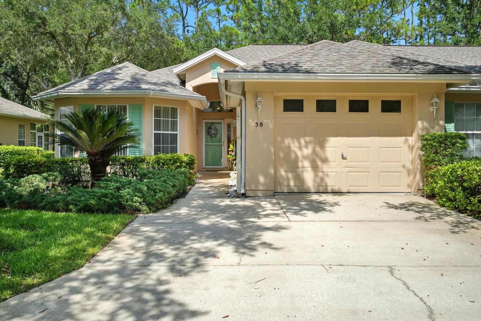 Welcome to the quaint and sought after community of Savannah Square located in the heart of beautiful Palm Coast! This villa is the essence of charm and privacy. You will not believe how spacious the living area & kitchen feel, upon entry. Spacious kitchen with lots of counter and cabinet space, including a breakfast nook area with window, overlooking the front entryway. Tile throughout, no carpet for a sleek & modern feel and making clean-up & maintenance a breeze! Bright and open primary bedroom suite that includes a walk-in closet and large bathroom with a large tiled walk-in shower! Enjoy the split plan layout for when family and friends visit as they can enjoy the privacy of the guest bedroom and guest bath at the front of the home. Oversized one car garage allowing for storage shelves and a vehicle. You will just love starting and ending your days on your large enclosed, under-air porch with wrap around windows allowing you to appreciate nature while you overlook the private wooded area and enjoy your cup of coffee. Perhaps what you will enjoy most of all is ease of maintenance you will have as the monthly HOA fees include roof and exterior maintenance, tree & shrub care, pest control, access to the clubhouse room and pool... It's time to love where you live in this gorgeous tree-lined community close to many conveniences and only 10 miles from the breathtaking Flagler Beach! : From Belle Terre Pkwy., turn right onto Pine Lakes Pkwy, right onto Wellington Drive, right onto Lafayette Lane. #38 will be
on your right after you wrap around the curves.