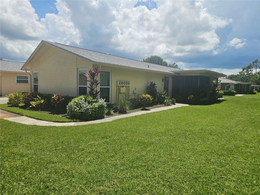 MOTIVATED SELLER!!! Welcome to your maintenance free, non-flood zone (high elevation), updated villa-style condo in the highly sought after 55+ golf community of Highland Lakes! This 2 bed 2 bath home has wood-like laminate flooring, carpet and tile in a spacious floor plan, living/dining room combo with an attached garage access, an abundance of natural light, and vibrant colors. The hallway leads to a large master suite with a walk-in closet, an en-suite with an updated vanity, lighting, and a beautiful step in shower. Bedroom 2 is a good size and offers an oversized double closet. the laundry station and utility sink are conveniently located in the garage, which is big enough for a car and a golf cart. enjoy cable tv, high speed internet, water, sewer, building insurance, trash removal, lawn care & exterior maintenance. Residents enjoy access to three private 9-hole executive golf courses, with unlimited free play, along with a practice putting green and driving cages to perfect your game. the vibrant clubhouse is ideal for social gatherings and features a great room and professional kitchen. there's also a library with computer stations, meeting rooms, and spaces for cards and billiards. For those with creative passions, the annex building includes areas dedicated to crafts, painting, and woodworking. To stay fit, you'll find an Olympic-sized pool, spa, pickleball, and tennis courts, bocce, and shuffleboard. The lodge, located on Lake Taron, offers a fishing pier, private boat ramp, and free RV and boat storage in a secure lot. Close to shopping, restaurants, beaches, and the vibrant downtown areas of Palm Harbor, Tarpon Springs, and Dunedin, your Florida adventure awaits!