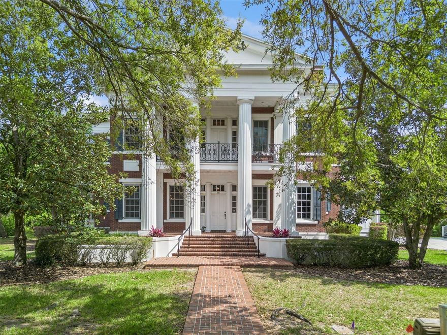 One or more photo(s) has been virtually staged. Welcome to 915 West Park Drive—an exceptional Colonial-style estate in the heart of Celebration, inspired by the historic Rosalie Mansion and custom built by Derrick Builders, known for their luxury homes in Golden Oak. Offered for the first time, this one-of-a-kind property sits on a rare double lot (lot 92 & 93), backing to a private preserve and positioned on a premier golf course corner—an unparalleled setting in Celebration. The expansive yard is truly one of a kind, offering an exceptional amount of green space with room to relax, entertain, or create your own outdoor retreat. Inside, the home features 5 bedrooms and 5 bathrooms, (with 1 bedroom 1 bath garage) including a spacious first-floor primary suite with tray ceiling, abundant natural light, and a well-appointed bath with dual separate vanities, walk-in shower, with two generous walk-in closets. You can also exit to the rear patio via the Primary bedroom. The home’s inviting interior is defined by open, light-filled living spaces, detailed millwork, and a gracefully designed staircase that anchors the main level. A richly appointed wood-paneled library with custom built-ins and fireplace creates a warm and timeless retreat. Just off the downstairs library is a convenient full bathroom, perfect for additional guests. Designed for both formal entertaining and everyday living, the home offers a formal dining room, a sun-filled casual dining area surrounded by windows, and a spacious family room. Architectural details include three fireplaces located in the formal dining room, library, and family room—adding warmth and timeless character throughout. The kitchen is thoughtfully designed with custom cabinetry, ample workspace, a separate sink in the island, and just outside the kitchen a charming built-in bar area, flowing seamlessly into the main living spaces. Upstairs, additional bedrooms are complemented by a large bonus/game room with soaring ceilings perfect as a media room, playroom, or private retreat. Each bedroom offering Jack/Jill style bathrooms to share on each side. Upstairs you will also find a built-in library area separating the bedrooms and a balcony with partial views of the golf course. Outdoor living is equally impressive, featuring an expansive full-width brick patio and covered porch framed by stately columns, along with a prominent brick chimney—creating a timeless setting for entertaining or quiet enjoyment of the surrounding preserve. Additional highlights include downstairs a walk-in laundry room with extensive built-in cabinetry offering extra pantry storage, and a detached 3-car garage apartment with 1 bedroom and 1 bath—ideal for guests, multigenerational living, or income potential. Blending timeless architecture, craftsmanship, and an irreplaceable homesite, this is a rare opportunity to own one of Celebration’s most distinctive and storied properties. (Note: Legal Description includes 2 lots)