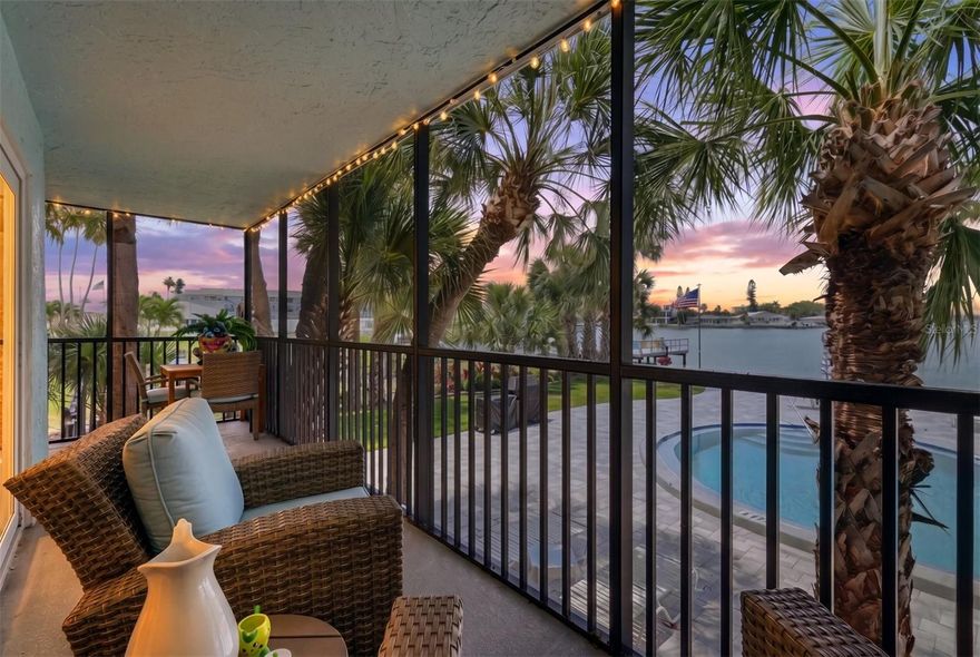 Experience elevated waterfront living at the exclusive Hemingway Condominiums, a boutique 14-residence community gracefully set along the Intracoastal waters of Boca Ciega Bay. Ideally positioned just one mile from the sugar white sands and vibrant coastal energy of St. Pete Beach, this beautifully renovated residence offers the best of waterfront serenity without premium beachfront pricing. A $150,000 luxury renovation completed in late 2023 brings a refined coastal-modern aesthetic throughout. The open-concept layout is anchored by a generous entertaining island with a cooktop, seamlessly connecting kitchen, dining and living spaces. Architectural ceiling beams introduce warmth and texture, while expansive windows and a screened balcony capture unobstructed bay views and spectacular sunset skies over Boca Ciega Bay. Positioned on the elevated first floor, the residence remained unaffected by past hurricane flooding, offering valuable peace of mind for waterfront ownership. Each day begins with calm water vistas and ends with dolphins passing through the bay, framed by native coastal birdlife in a truly natural setting. The spacious primary suite provides a quiet retreat, while the secondary bedroom offers exceptional flexibility for guests, a home office or seasonal stays, well-suited for full-time living, a coastal escape or investment use. The Hemingway community is currently undergoing a series of enhancements, including building common area improvements, refreshed paint, a resurfaced waterfront pool and entertainment deck, a new elevator, upgraded carports and renovated common areas. The redesigned lobby introduces modern flooring, updated ceilings and new community mailboxes. All property improvements are fully funded with no planned assessments. Residents enjoy an oversized waterfront amenity area featuring a heated pool, spa and barbecue gathering spaces overlooking the bay, an intimate resort-style experience rarely found in a boutique setting. HOA coverage includes building and flood insurance, along with traditional condominium ownership and no land lease, further enhancing long-term value and ease of ownership. Conveniently located near Publix, Winn-Dixie, Walmart Market, acclaimed local dining including Tom Peter’s Famous Smoked Fish and just 0.3 miles from Pasadena Hospital and Fire Station 20 and other local services. Downtown St. Petersburg is 7.5 miles and Tampa International Airport is 27 miles from the residence. This exceptional waterfront residence captures the best of Florida coastal living.